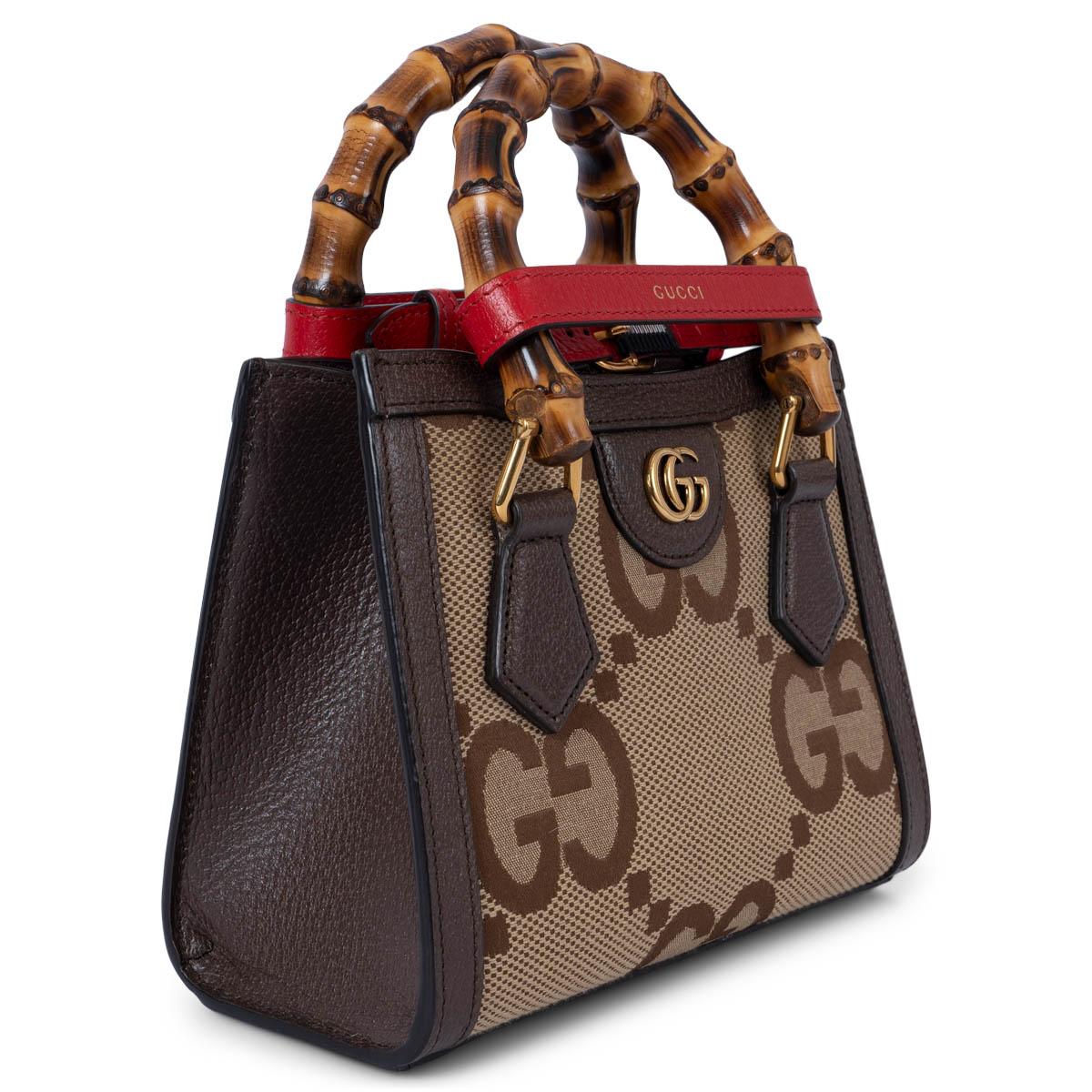 100% authentic Gucci Diana Mini tote bag in camel and ebony jumbo GG canvas featuring brown leather accents. The design comes with 2 decorative belt handle shapers in red leather. Lined in ivory canvas with an open pocket against the back. Has been