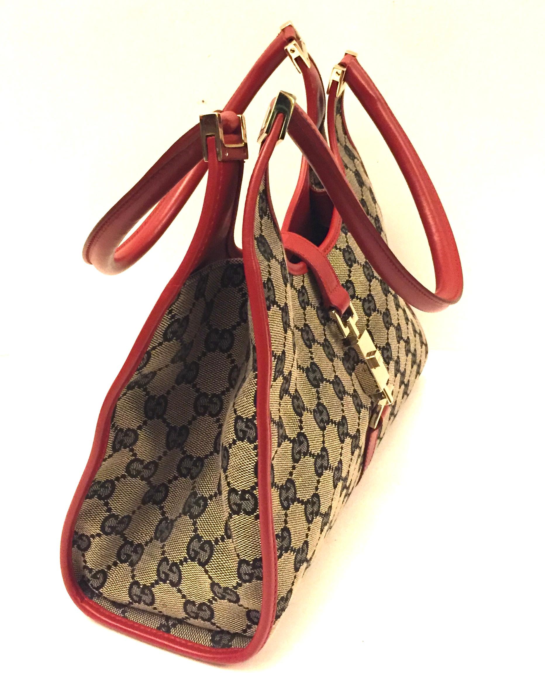 - Gucci canvas monogram red piping handbag. 

- Press lock closure. 

- Interior pocket zip closure. 

- Measurements: 31cm x 26cm x 10cm. Drop: 22cm. 

 