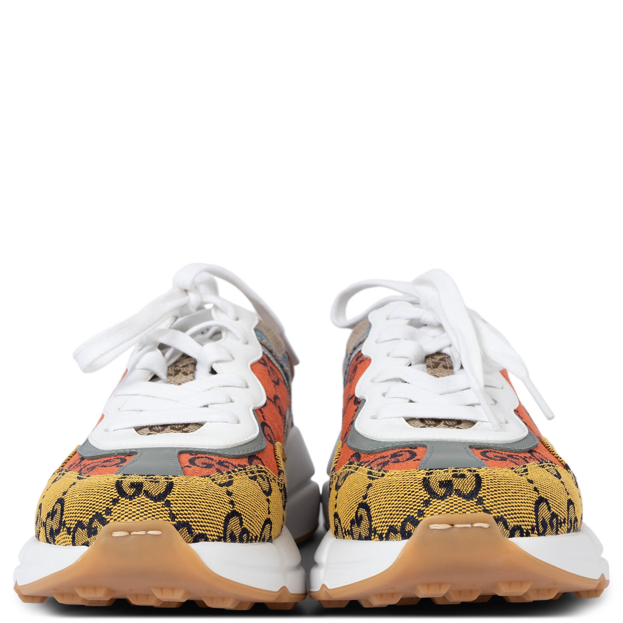100% authentic Gucci Rhyton sneakers in orange, yellow, beige, light blue and burgundy GG Monogram canvas featuring chunky white rubber sole and light beige terrycloth lining and leather trim. Have been worn once inside and are in virtually new
