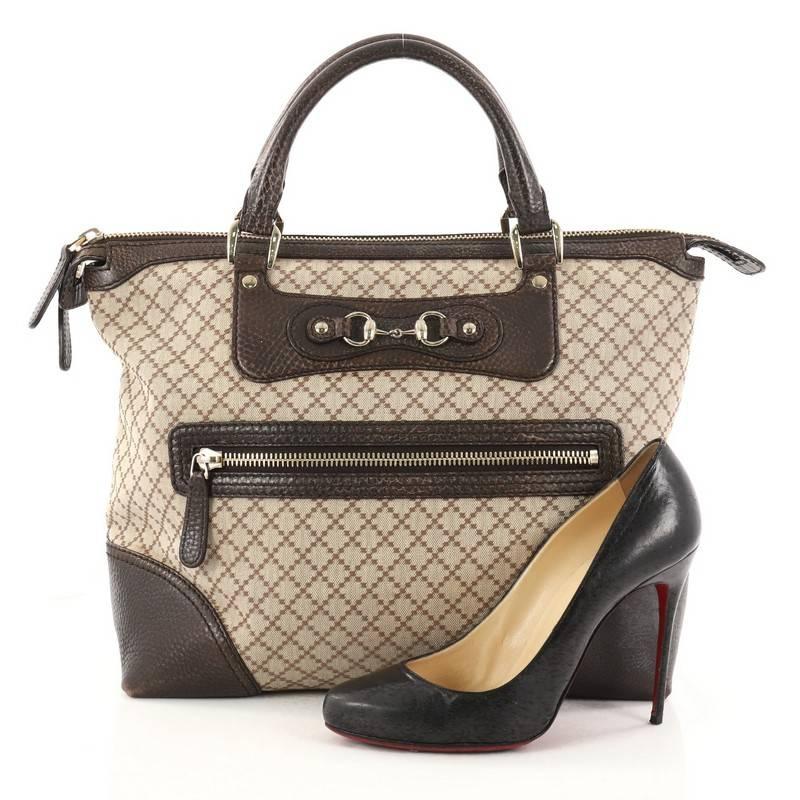 This authentic Gucci Catherine Tote Diamante Canvas with Leather Large is sophisticated and elegant in style perfect for everyday use. Crafted in Gucci’s brown diamante canvas with brown leather trims, this chic tote features dual-rolled leather