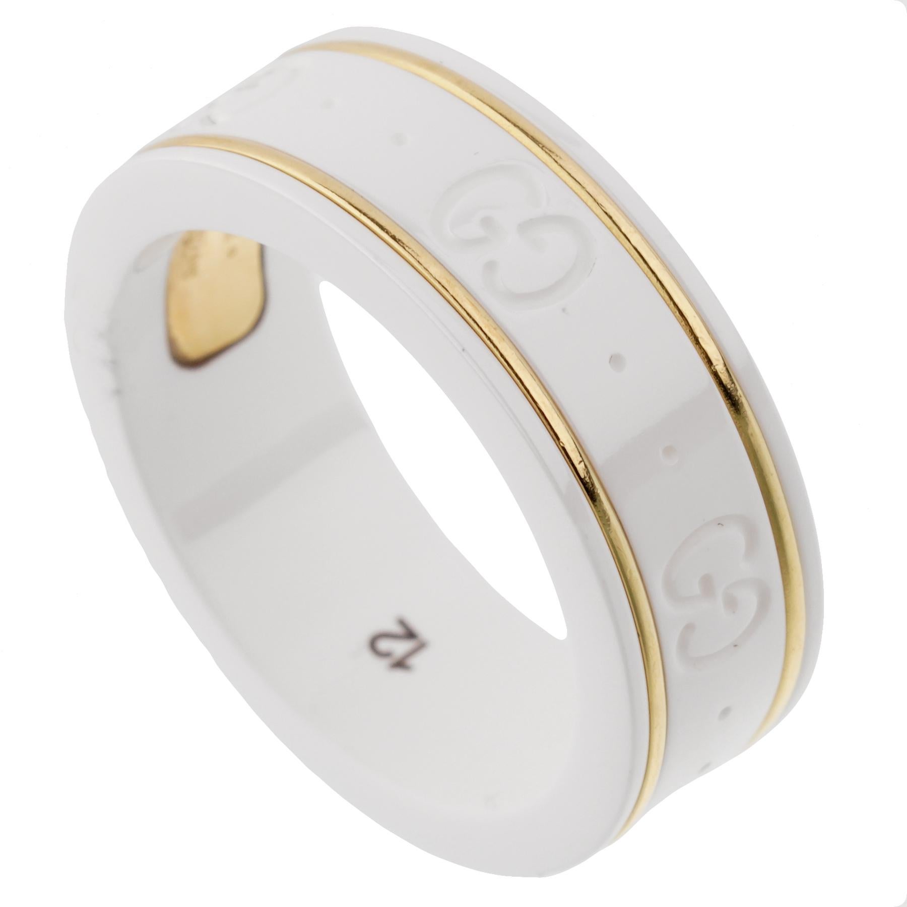 A chic GUCCI ceramic ring showcasing the iconic GG motif encircling the band with 2 gold bands. The ring measures a size 6
