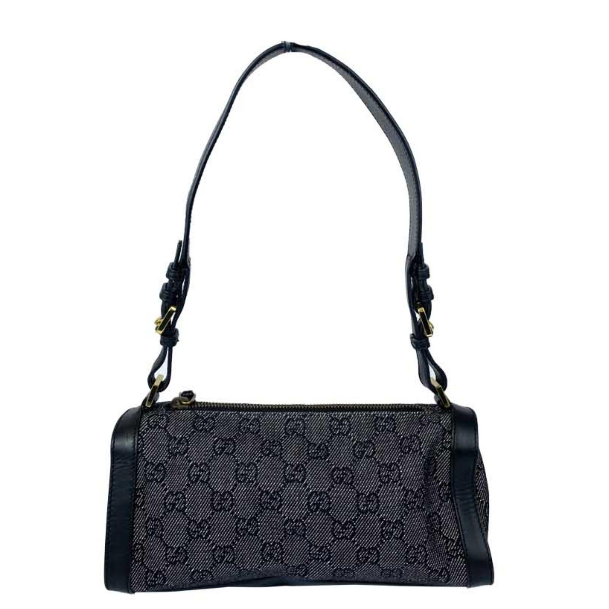 Gucci mini charcoal canvas handbag. Monogram print canvas with gold hardware and black leather strap and trim. One zipper pocket inside. In excellent condition slight wear on the zipper.

Measurements:
Height: 12cm
Width: 23.5cm
Depth: 7cm
Handle