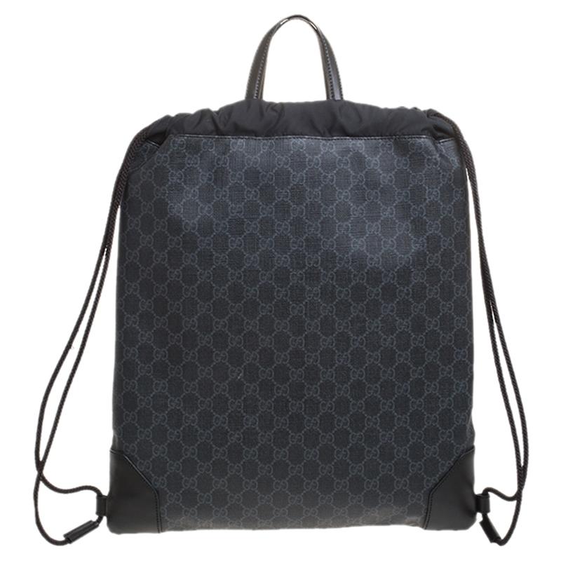 This stylish backpack from Gucci is made from signature GG Supreme canvas and is enhanced with the web detail. The bag features a drawstring closure and shoulder straps. It has a spacious interior that is lined with satin. The simple design makes it