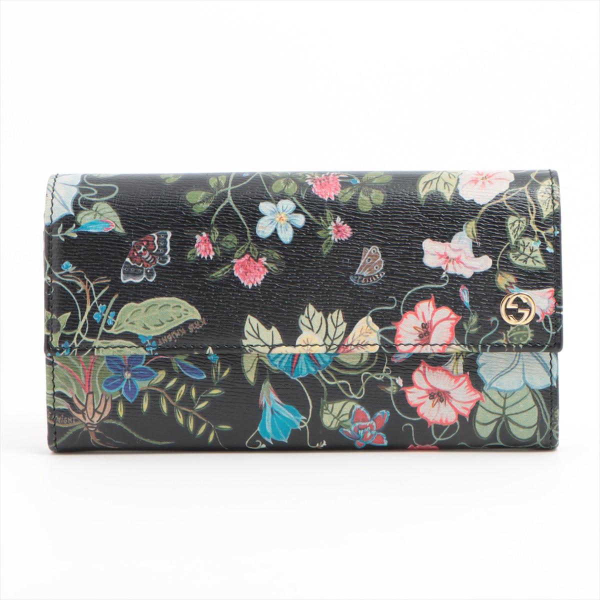 The Gucci Chris Knight Floral Leather Long Wallet in black is a sophisticated accessory that seamlessly blends classic elegance with modern design. Crafted from high-quality leather, the wallet features iconic Floral print, adding a touch of