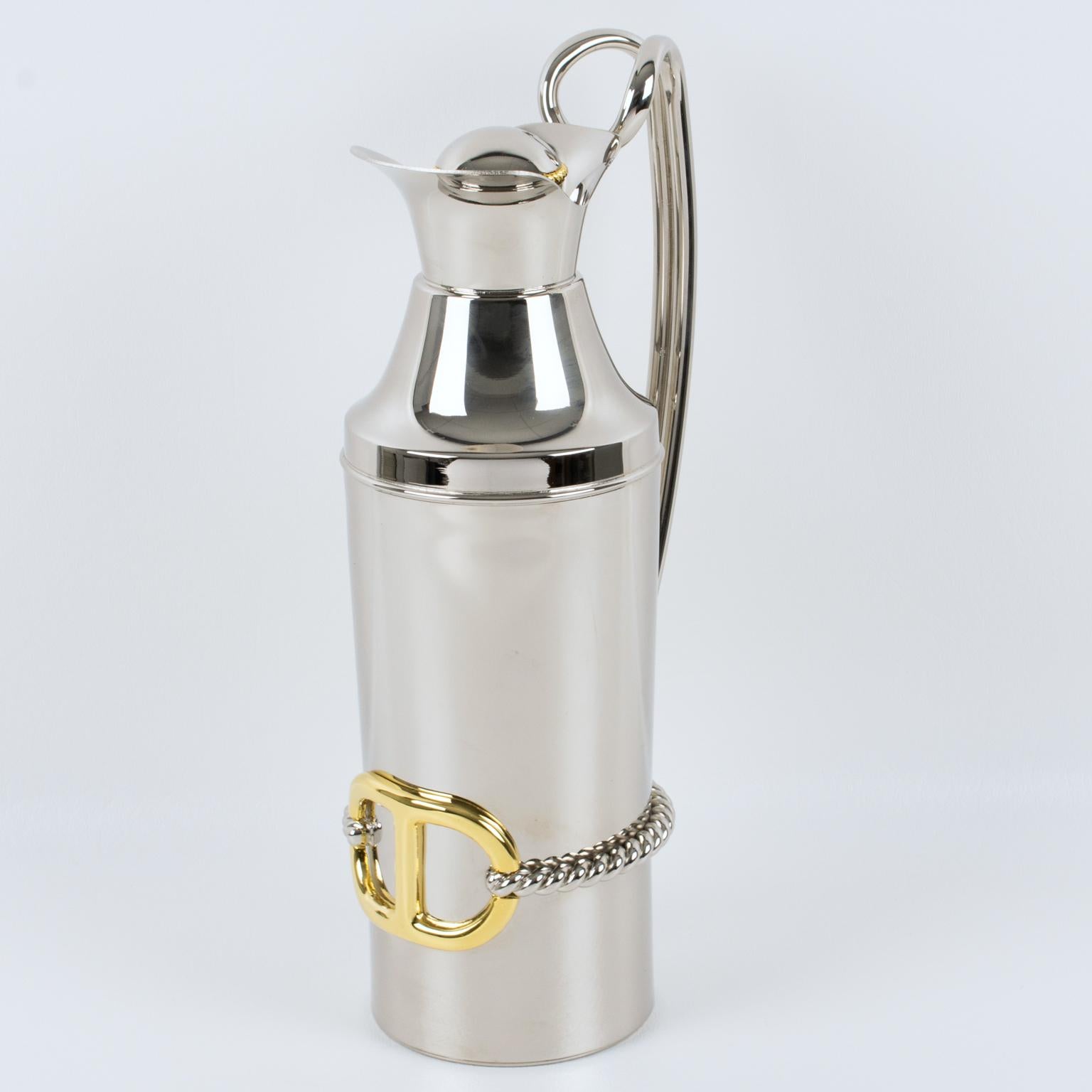 Gucci designed this luxury gilt and silvered metal barware bar thermos or insulated decanter. The piece was crafted in Italy circa 1980. This carafe boasts a sleek and modernist form made from silvered metal. 
The bar piece is adorned with a tall