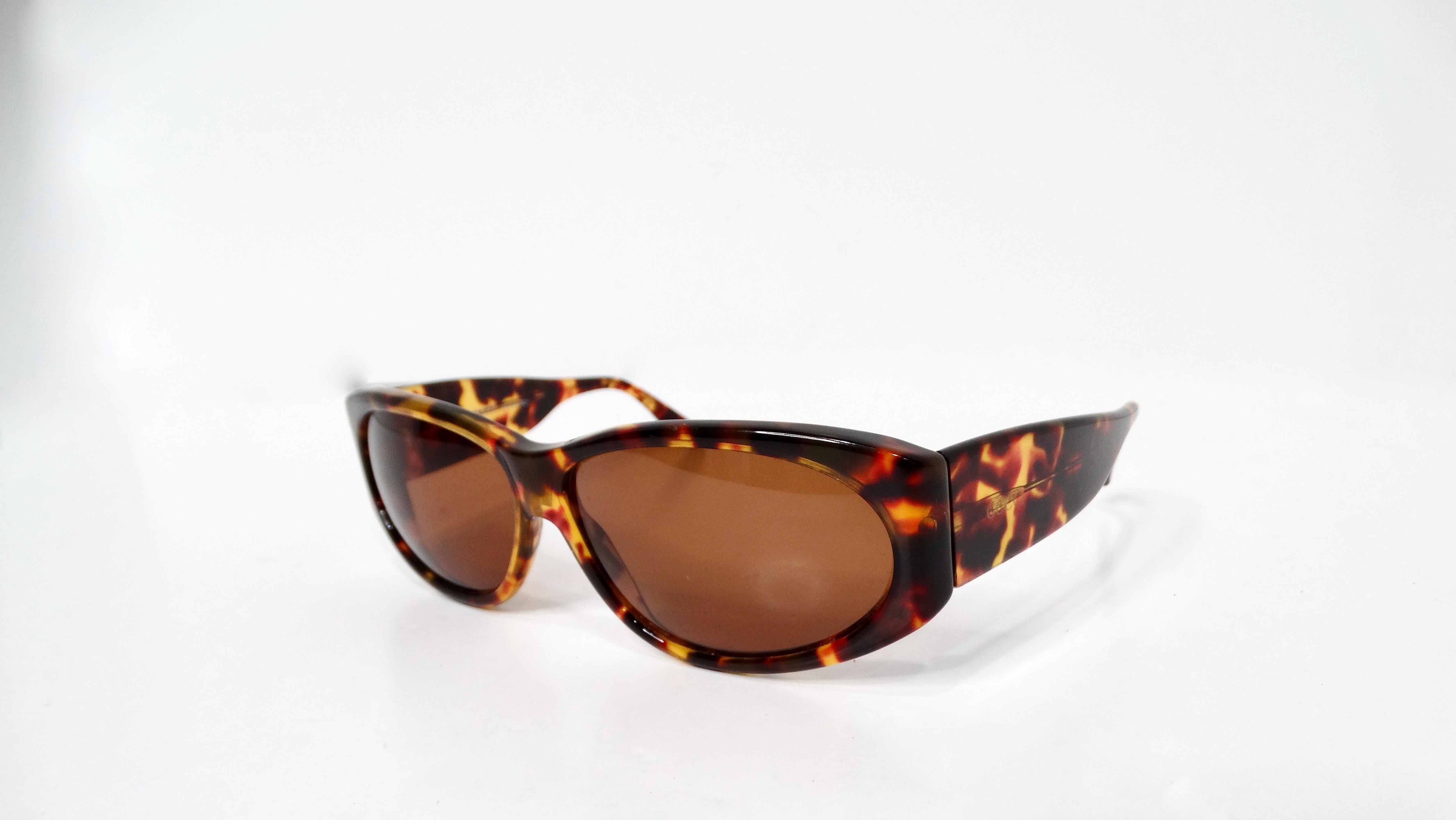 The Vintage Gucci Chunky Tortoise Style Sunglasses are a timeless accessory that effortlessly combines retro charm with modern sophistication. Featuring bold, oversized frames crafted from high-quality tortoise-patterned acetate, these sunglasses