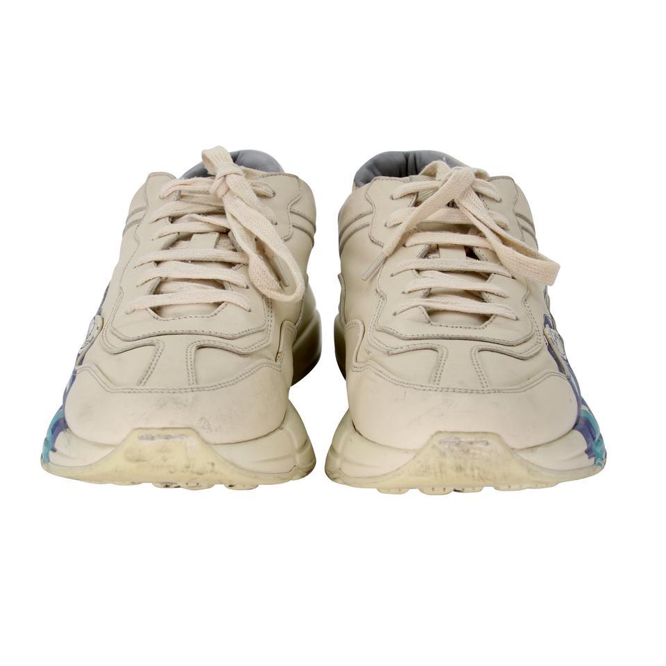 Gucci Chunky Waves 12 Leather Rhyton Logo Sneakers GG-0525N-0214

These Gucci sneakers are edgy and comfortable. Featuring ivory leather with blue waves on the outer sides. Rubber thick sole and bulky construction makes these super comfortable.