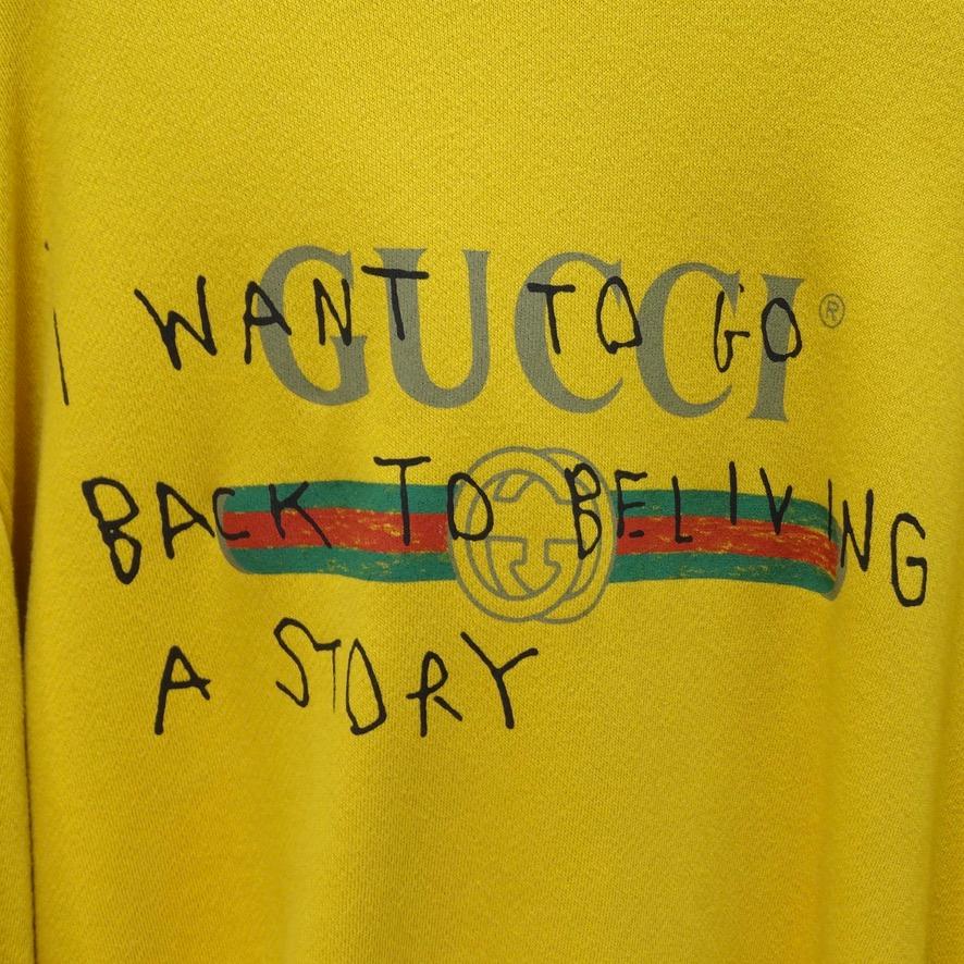 Incredibly soft Gucci graphic hoodie in a stunning mustard yellow color designed in collaboration with artist Coco Capitán in 2017. Graphic reads 'I want to go back to believing a story' over a Gucci logo. Marked size XXL, the fabric is pretty heavy