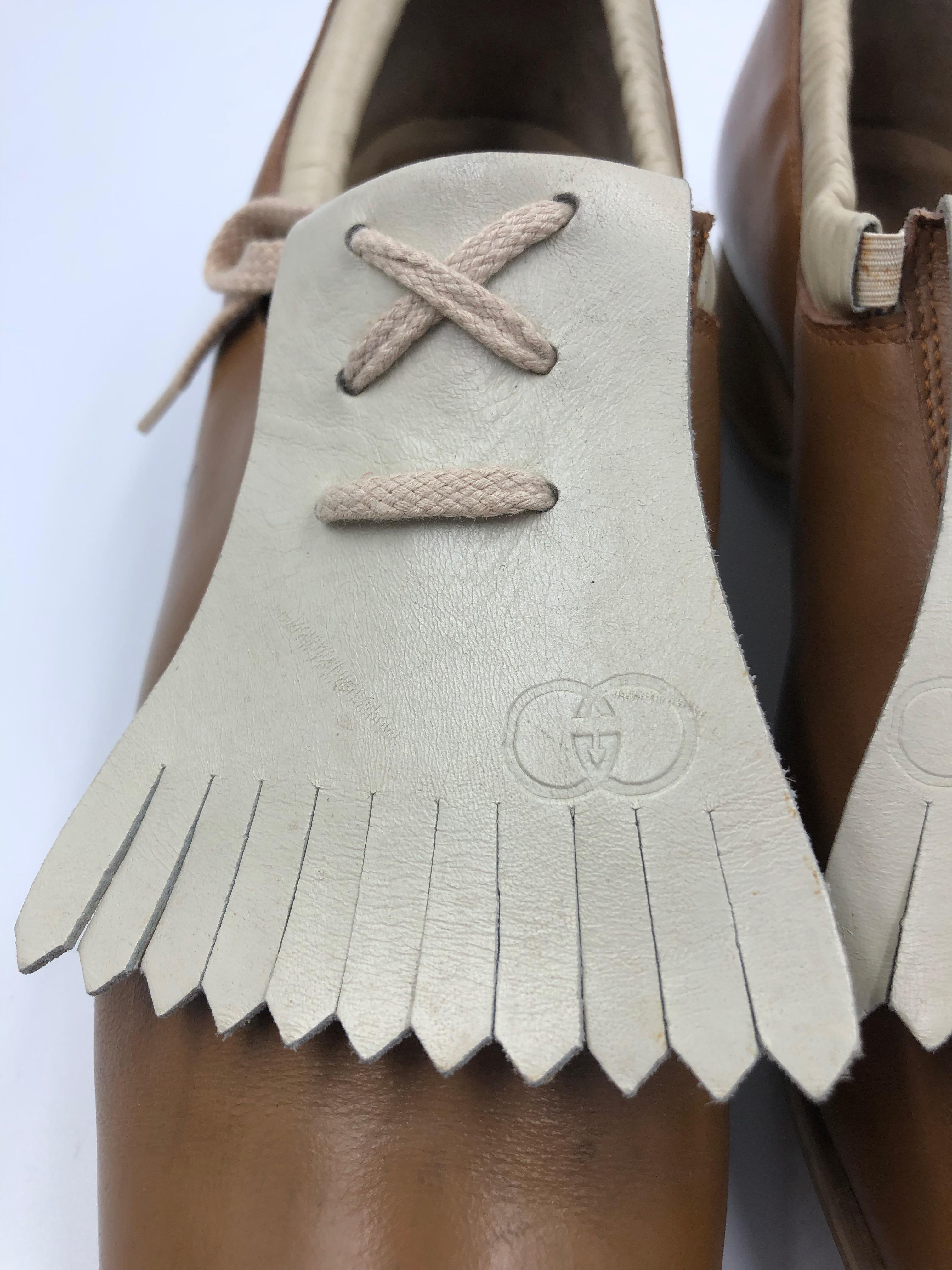 Gucci Collectors Vintage Golf Shoe with marked Gucci Cleats. Tan and Cream with fringe flap.
Golf shoe marked inside 39 1/2 ; we tried on the golf shoe and it fits more of a real 8 1/2. This is an ultimate piece for a Gucci collector.  Condition