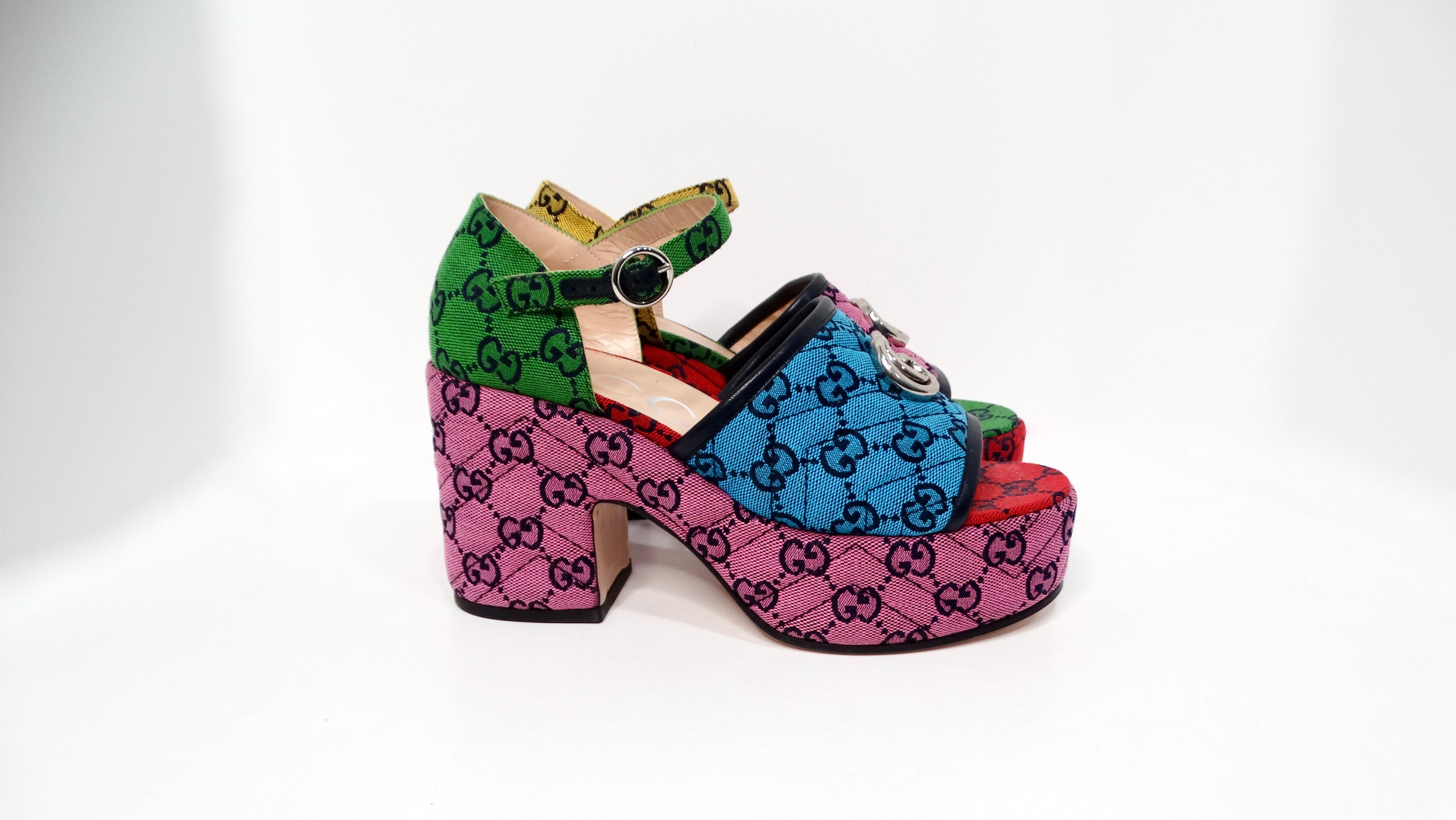 The Gucci Color-Block Monogram Logo Platform Sandals are a vibrant and playful addition to any fashion-forward wardrobe. Adorned with a captivating color-block design in purple-pink, blue, green, red, and yellow, these sandals make a bold statement