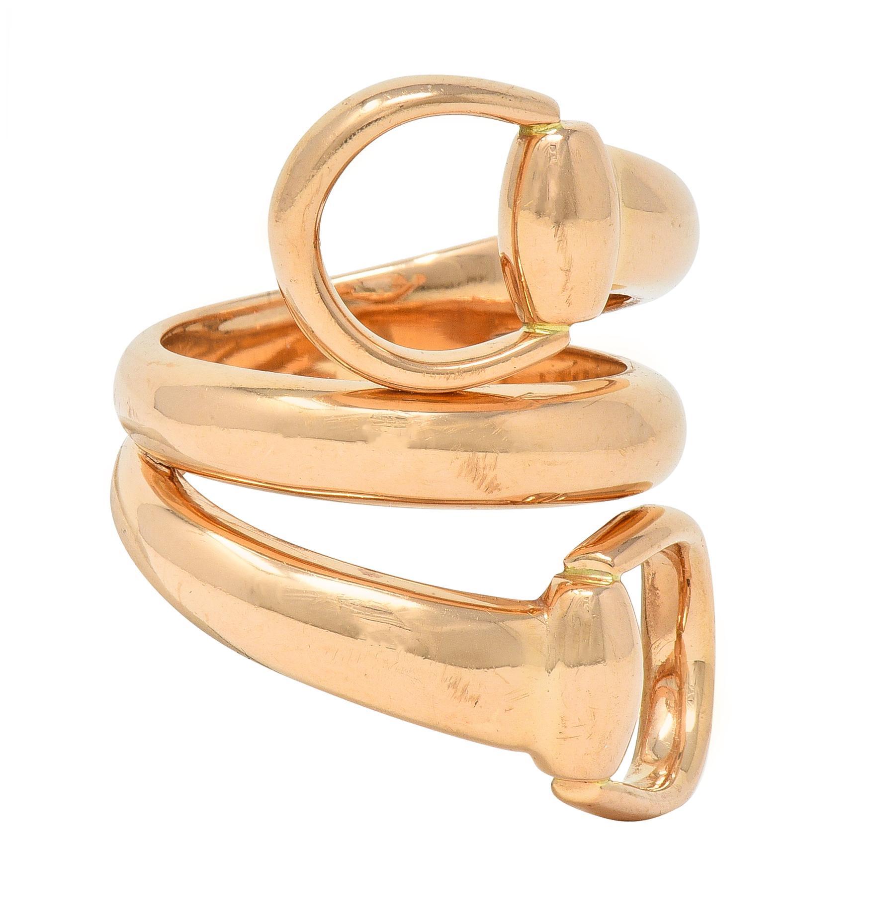 Designed as a bypass-style wrap ring
Terminating with stylized horsebits
Completed with high polish finish 
Stamped for 18 karat gold
Fully signed for Gucci
Circa: 2000s
Ring size: 6 1/2 and not sizable 
Measures north to south 29.5 mm and sits 4.0