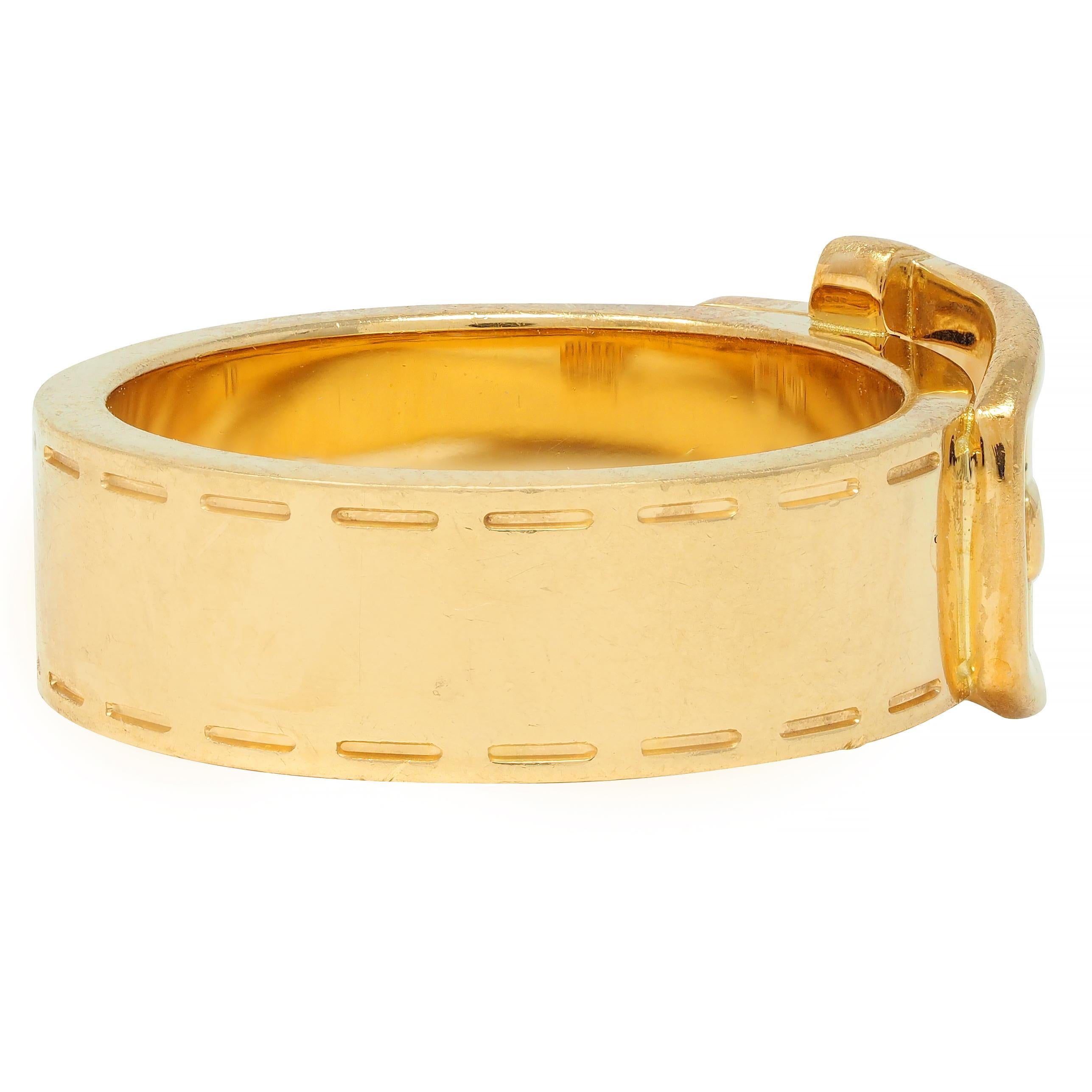 Designed as a wide band with a stylized belt buckle motif appliqué
Buckle is inscribe with 'GUCCI' logo 
Accented by stitch motif engraving along edges
Completed by high polish finish
Stamped with Italian assay marks for 18 karat gold 
Fully signed