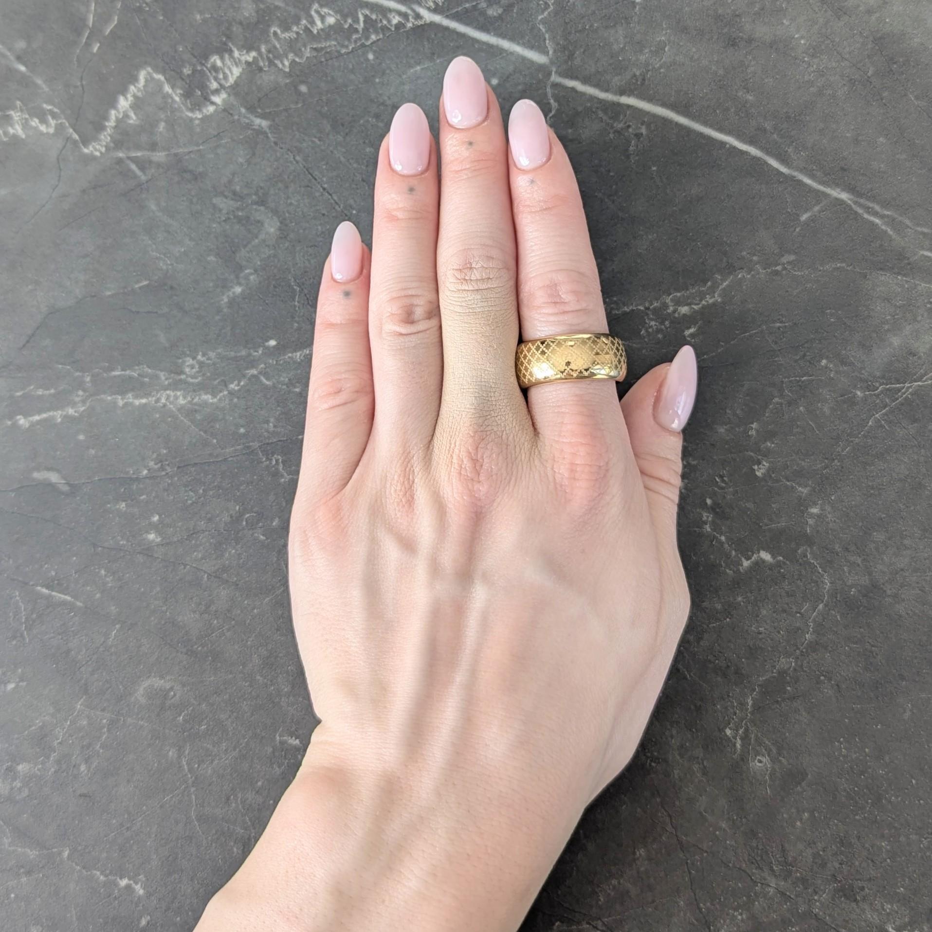 Designed as a wide band ring with engraved criss-cross pattern
Matte and accented by interlocking 