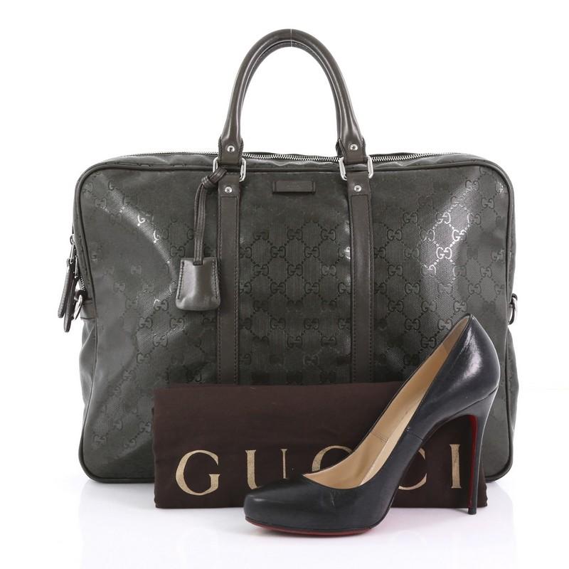 This Gucci Convertible Briefcase GG Imprime Large, crafted from green GG imprime leather, features dual rolled leather handles, leather trims, and silver-tone hardware. Its top two-way zip closure opens to a dark green fabric interior with side zip
