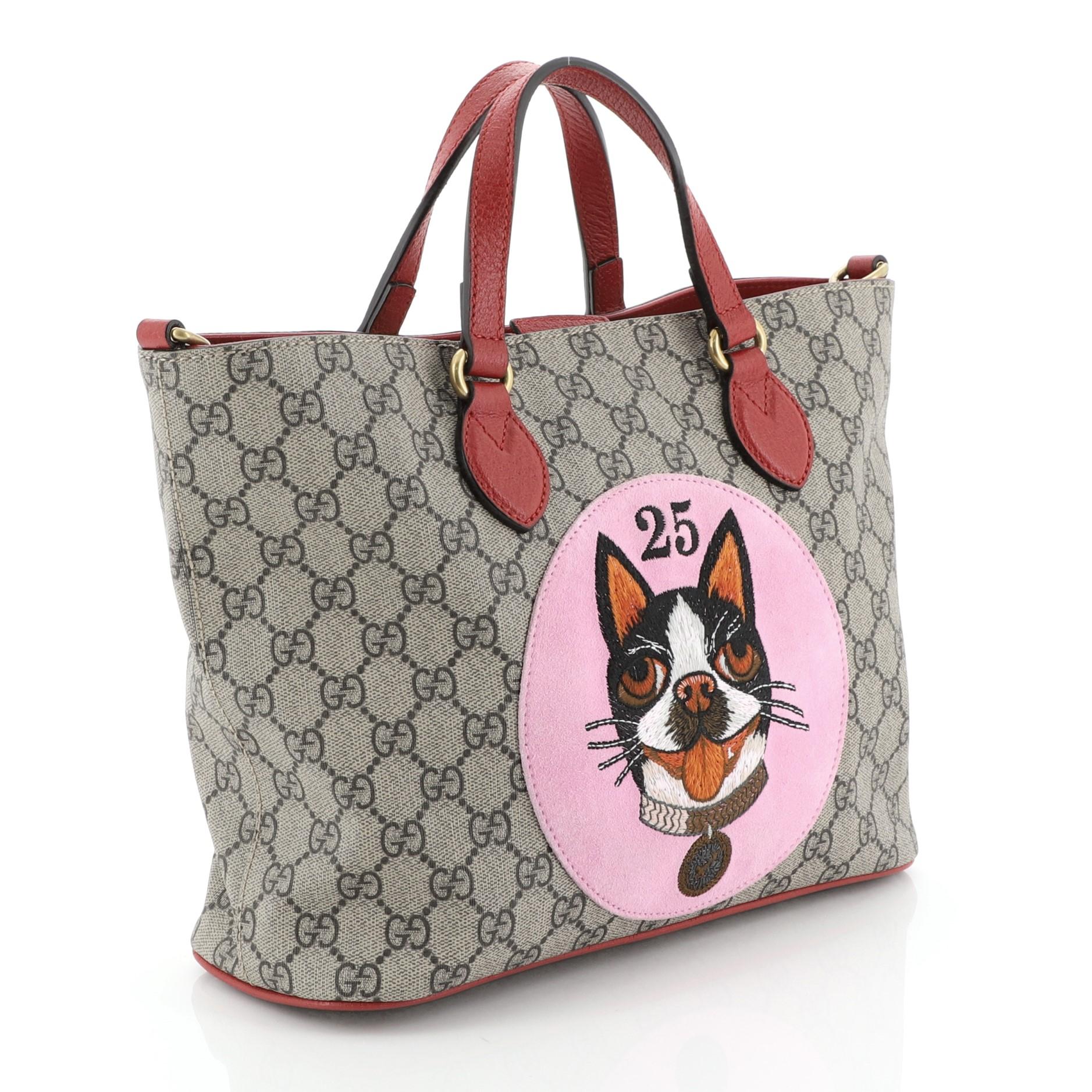 This Gucci Convertible Soft Tote Bosco Print GG Coated Canvas Small, crafted in brown GG coated canvas, features dual flat leather handles, a suede patch with the image of Bosco the Boston terrier, and aged gold-tone hardware. Its magnetic closure