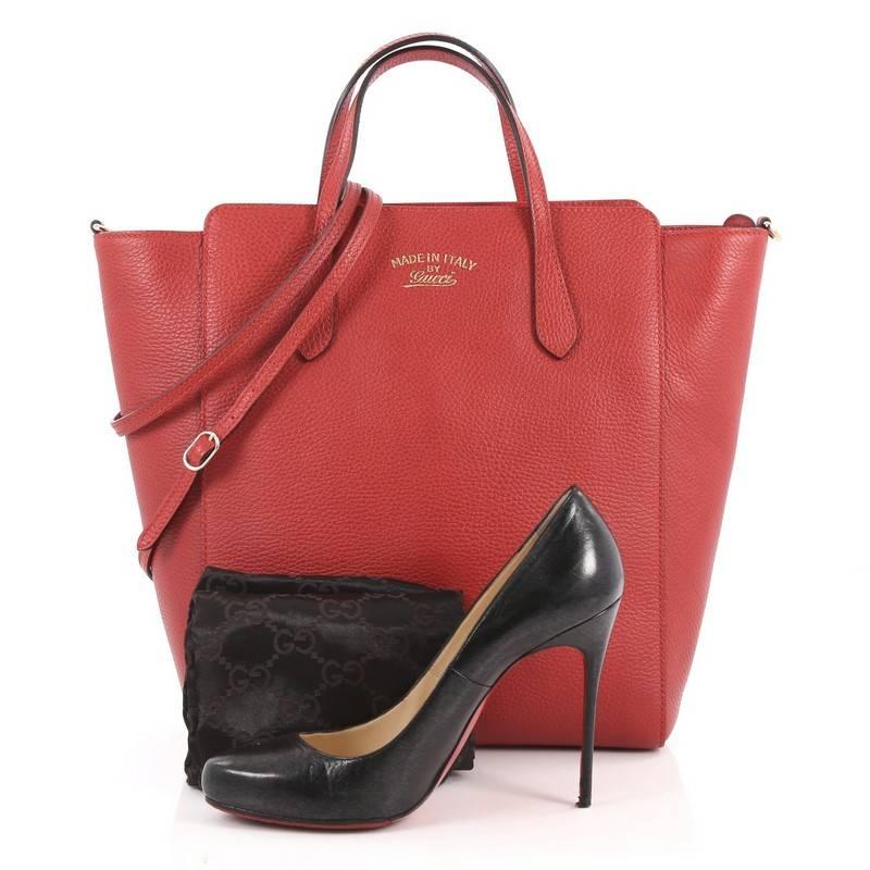 This authentic Gucci Convertible Swing Tote Leather Tall is modern and sophisticated in design. Crafted in red leather, this elegant tote features tall dual-slim handles, Gucci stamped logo at the front, expanded wing silhouette, and gold-tone