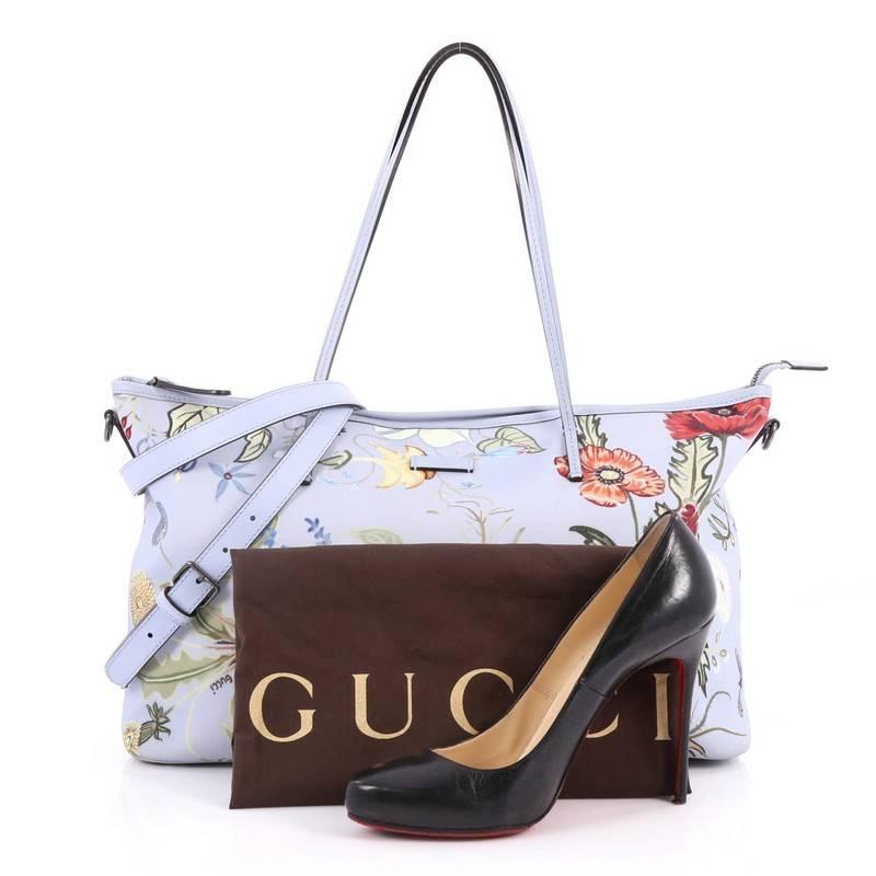 This authentic Gucci Convertible Zip Tote Flora Canvas Large is stylish in design perfect for modern fashionistas. Crafted in blue flora canvas, this elegant tote features dual slim leather handles, blue leather trims, and gunmetal-tone hardware