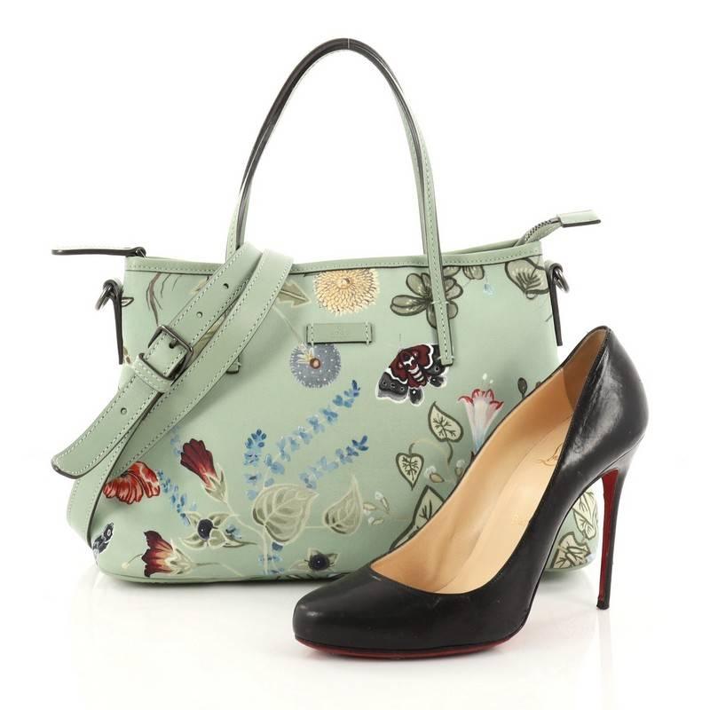 This authentic Gucci Convertible Zip Tote Flora Canvas Medium is stylish in design perfect for modern fashionistas. Crafted in mint green flora canvas, this elegant tote features dual slim leather handles, mint green leather trims, and gunmetal-tone