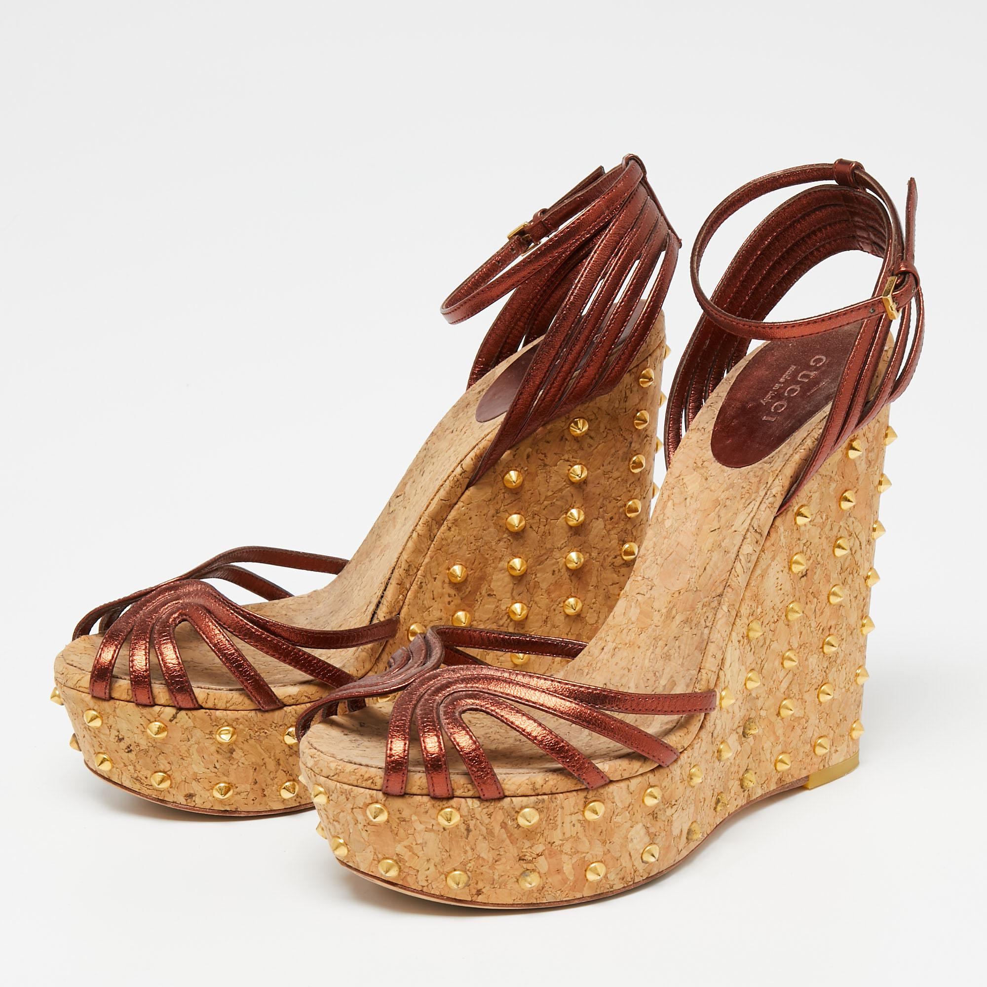These sandals from Gucci have been designed to lift your style. They flaunt copper-hued leather straps to secure your feet perfectly and are elevated on studded cork wedge heels. Pair them with a dress for a fashionable brunch outing and get set to