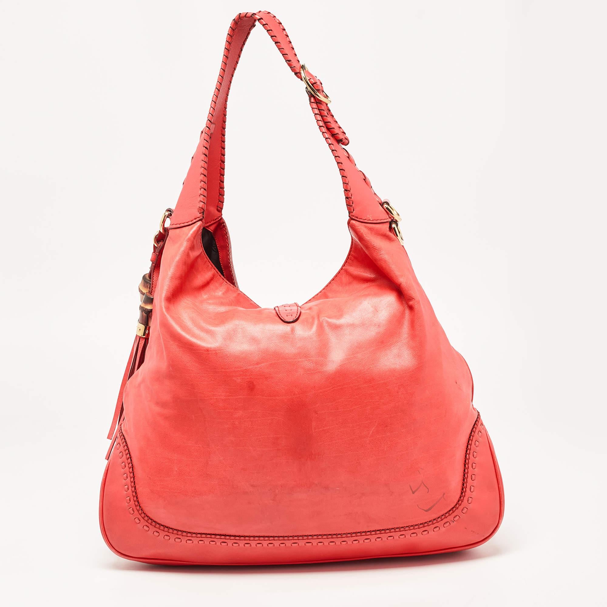 Gucci has always offered a bevy of cult-favorite bags, just like this New Jackie hobo created as a homage to Jacqueline Kennedy Onassis. It is crafted from leather and flaunts a coral red shade. A piston push-lock closure opens to a roomy interior