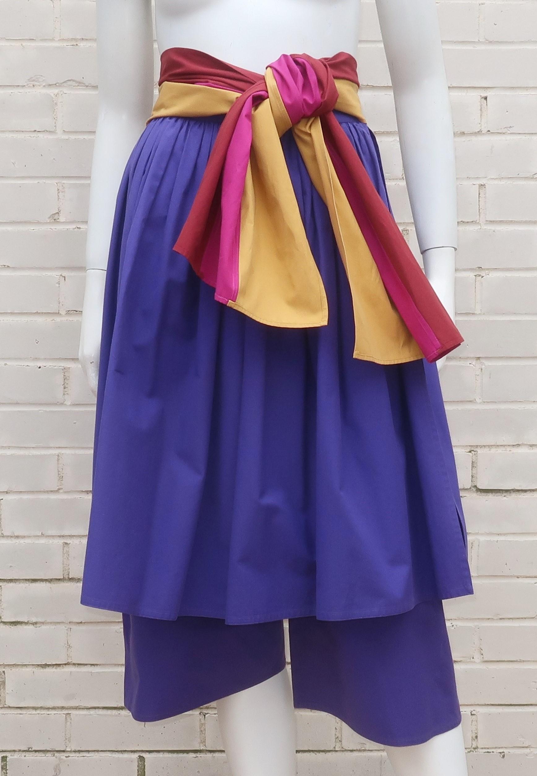 This summery 1970's confection from Gucci combines colorful cotton with a unique silhouette to provide a fun design.  The contrasting color combination of royal purple with a built-in striped sash of goldenrod, fuchsia and burgundy is a knockout. 