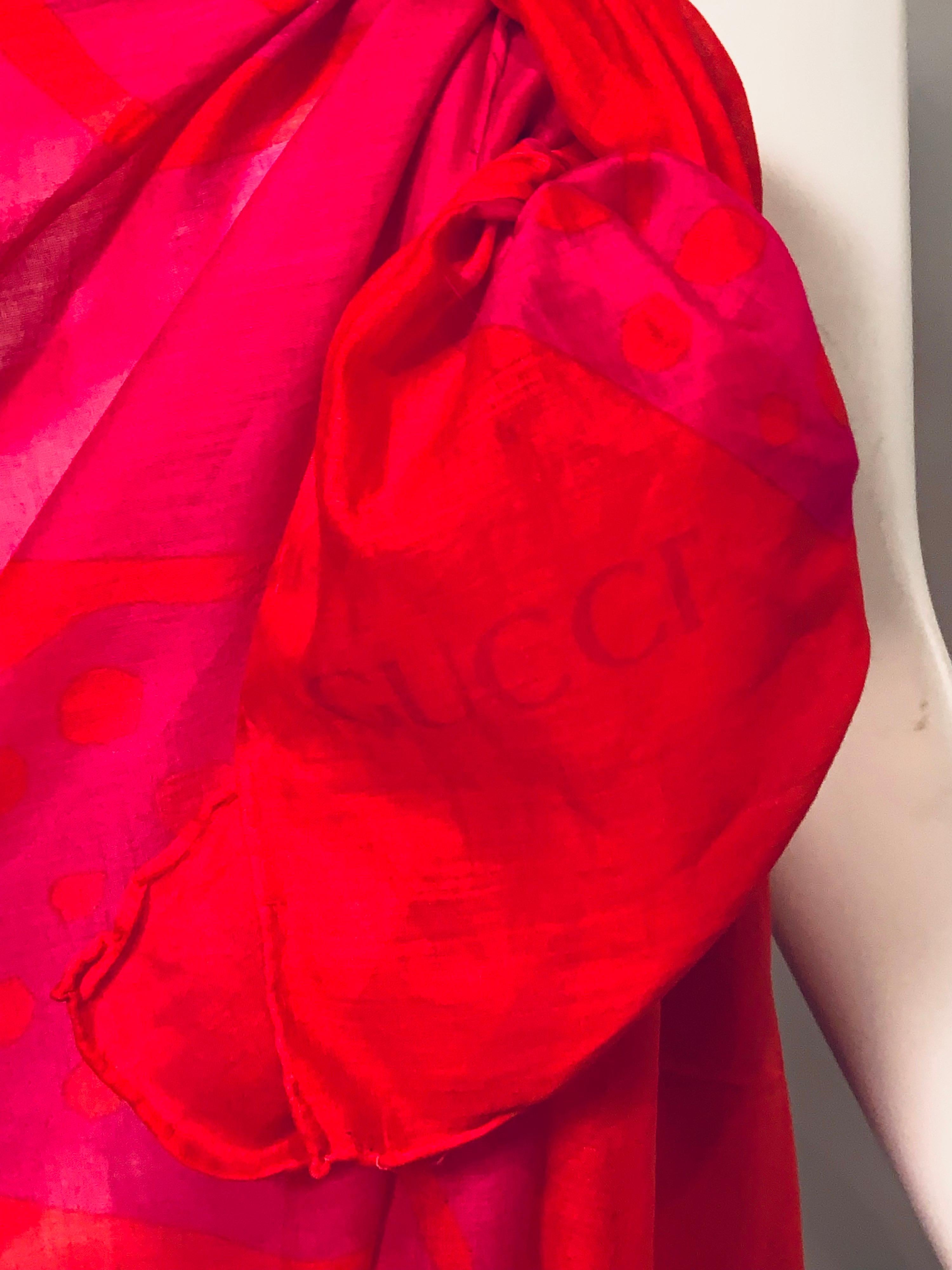 This Gucci pareo wrap or shawl is a real dazzler.  Shocking pinkis used for a large butterfly wing set against a red/orange background.  It is all cotton and in excellent condition.  It is signed Gucci in one corner, as well as on 
the label. 