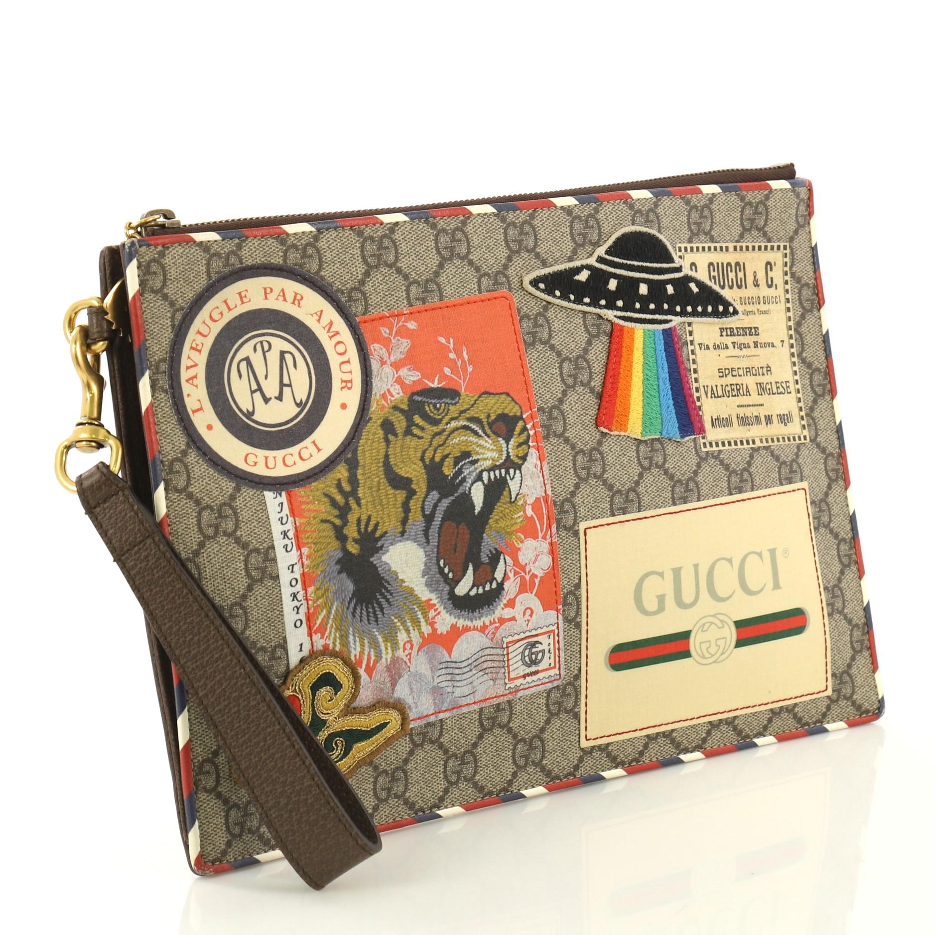 This Gucci Courrier Pouch GG Coated Canvas with Applique, crafted in light brown coated canvas, features a hand strap, applique design, and gold-tone hardware. Its zip closure opens to a beige canvas interior with multiple card slots. 

Estimated