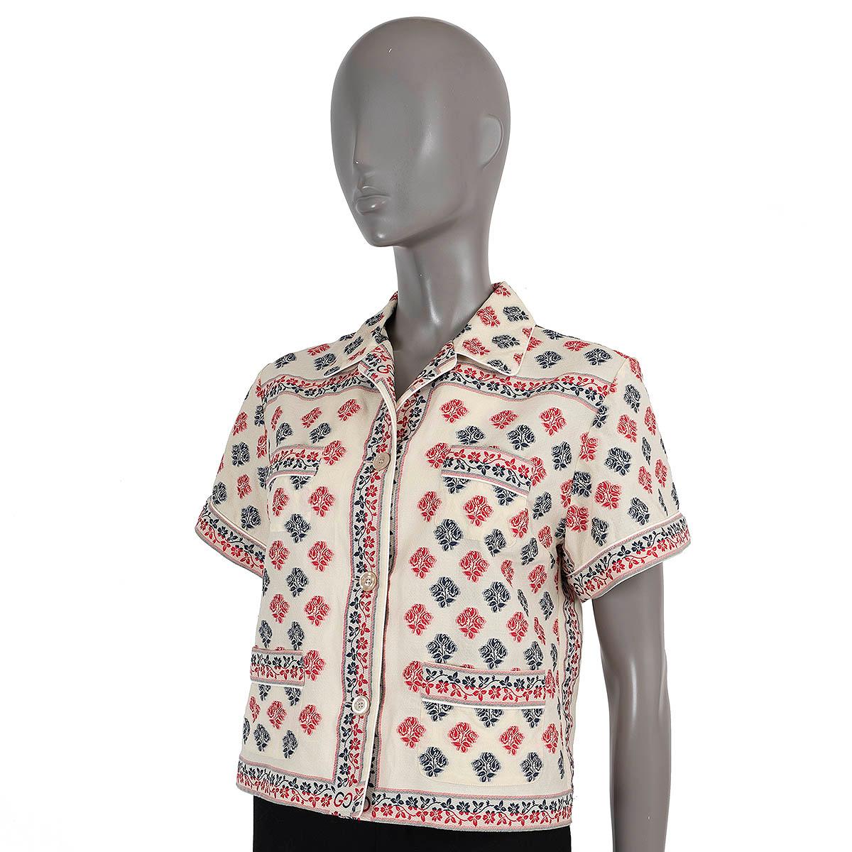 100% authentic Gucci floral jacquard shirt in ivory, pink and navy blue cotton (67%) and polyester (33%).  Features cuban collar, short sleeves, two pockets at the chest and waist. Closes with buttons on the front and is unlined. Has been worn and