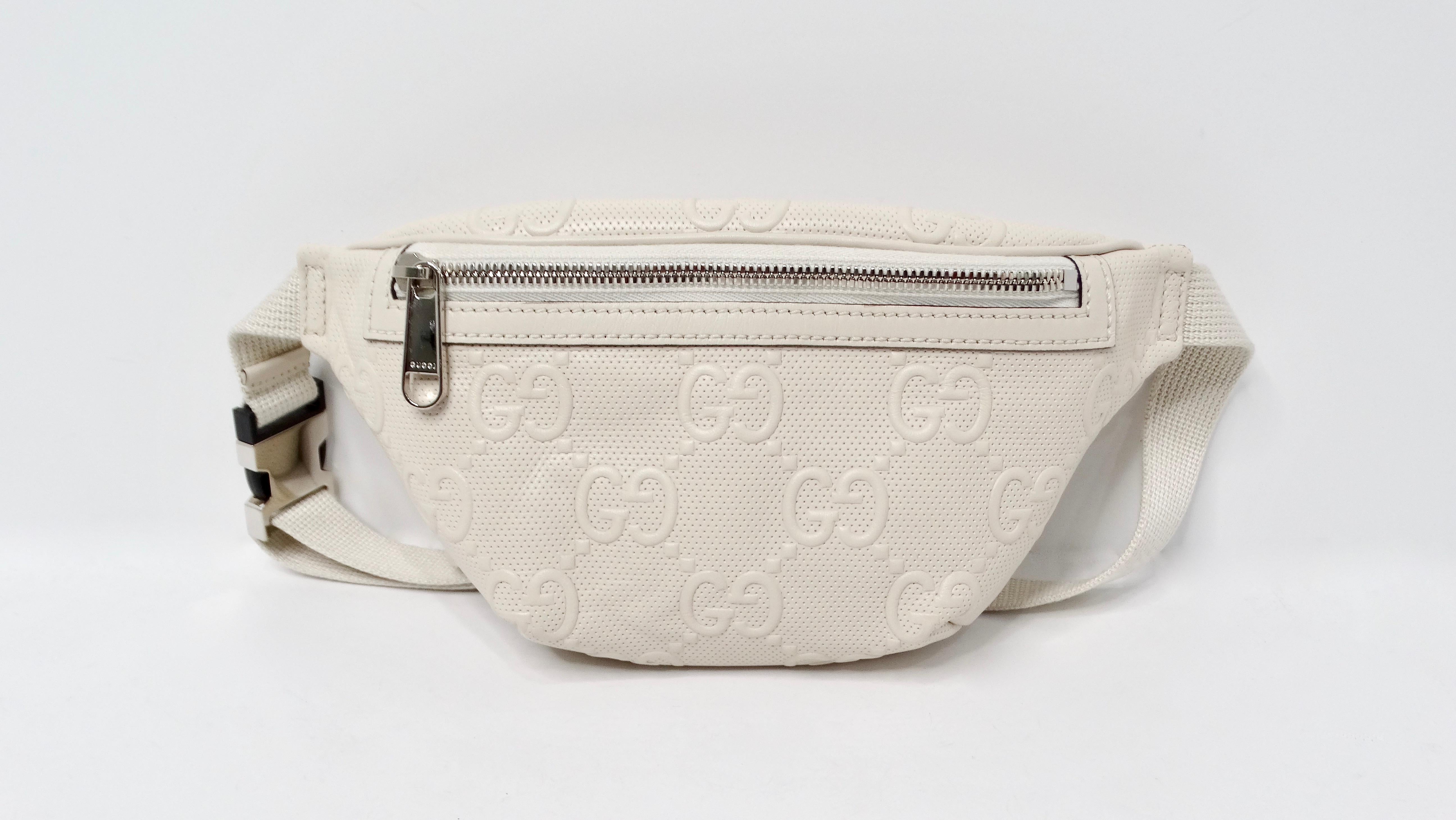 The Gucci Cream Calfskin GG Tennis Embossed Belt Bag is a luxurious accessory that seamlessly blends style and functionality. Crafted from high-quality cream calfskin leather, this belt bag features the iconic GG logo embossed on its surface, adding