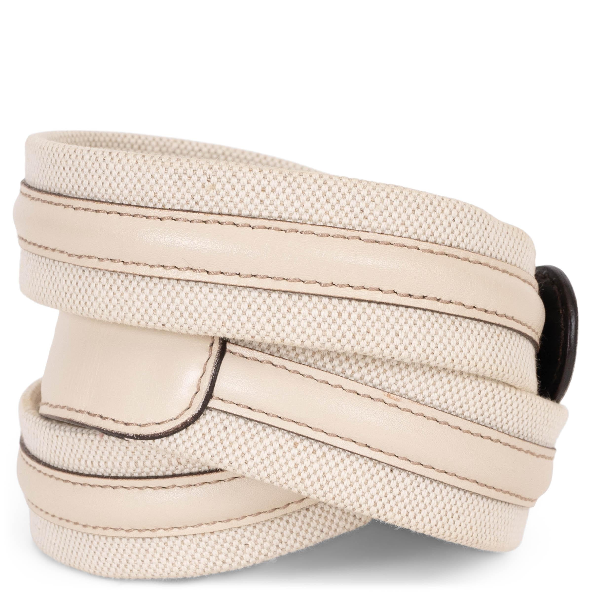 This 100% authentic Gucci belt in cream canvas with tonal leather trims combines understated elegance with signature house detailing. Featuring a light gold-tone buckle adorned with bamboo, it adds a subtle yet iconic finish to both casual and