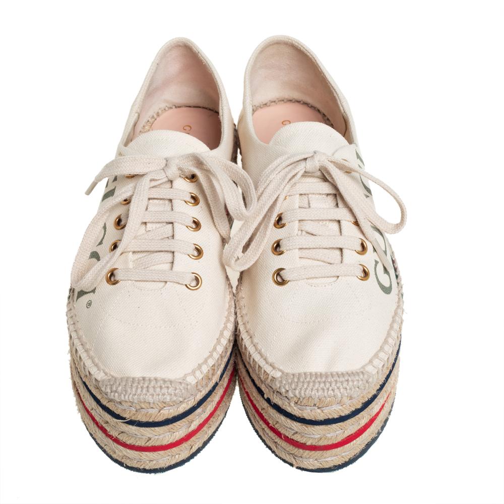 Step out in style with these chic espadrilles from Gucci! These cream platform shoes are crafted from canvas and feature round toes, brand detailing, lace-ups, and espadrille platforms that offer an elevated walk. This is one pair you definitely