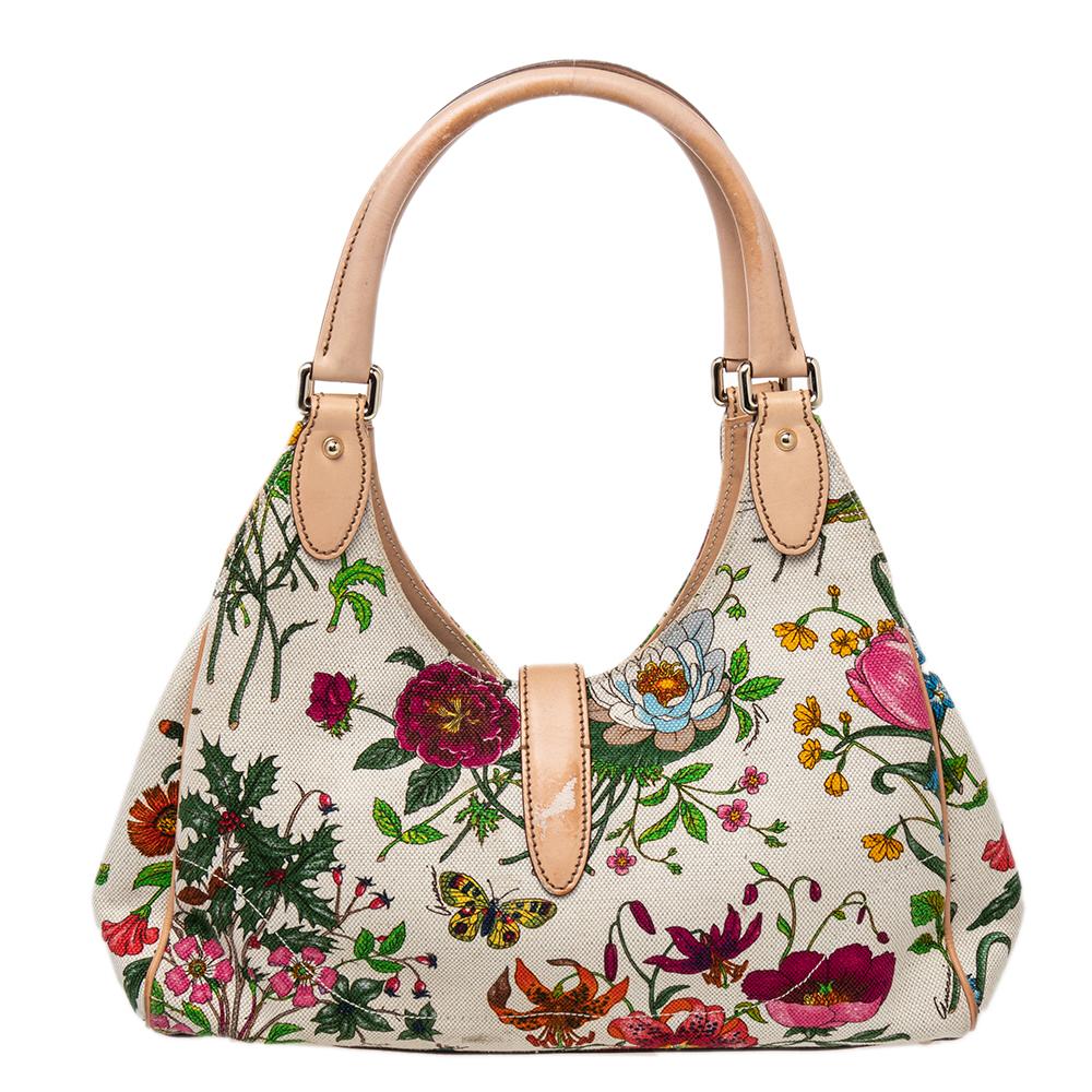 A handbag should not only be good-looking but also durable, just like this pretty Jackie O hobo from Gucci. Crafted in Italy and made from floral canvas and leather, this gorgeous hobo bag comes in a lovely shade of cream. This creation has a
