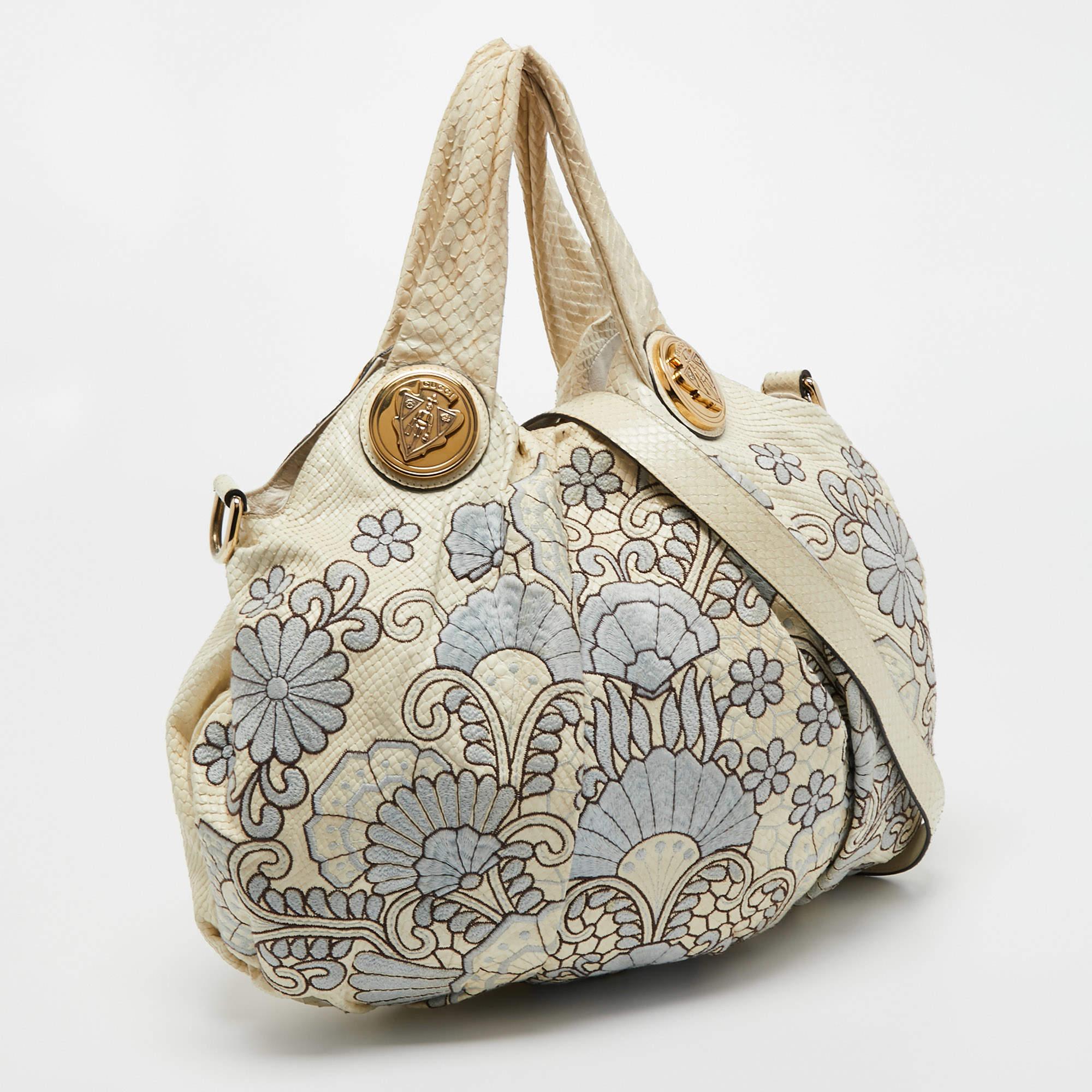Let your everyday style look cute and chic as you carry this Hysteria hobo from the House of Gucci. It is designed using cream python skin, which is highlighted with floral embroidery. It comes with two handles, a spacious leather-canvas interior,