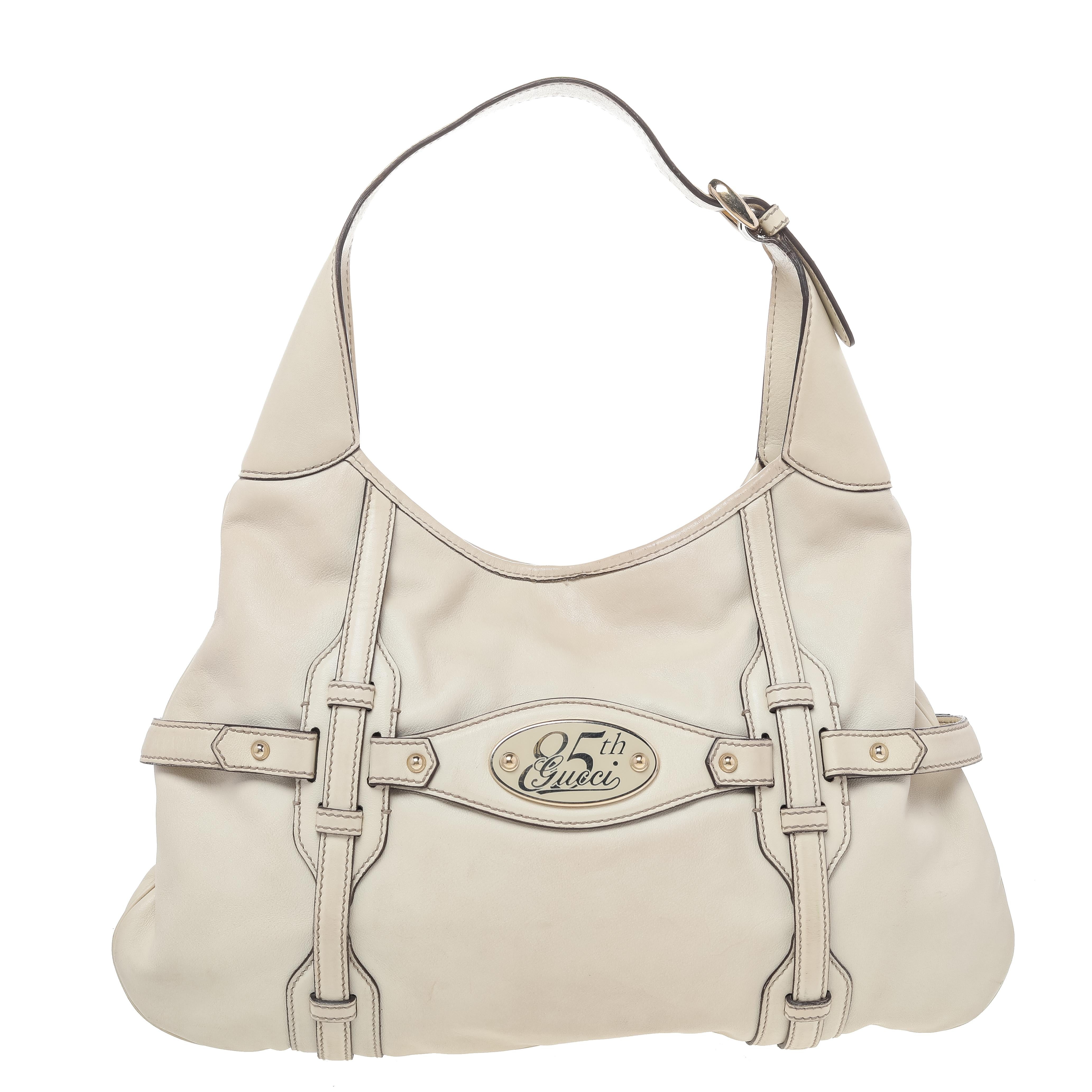 This Gucci 85th Anniversary Hobo is just what you need to add elegance to your appearance. The exterior is made from cream leather with matching gold-toned accents. This can be used as an everyday bag.