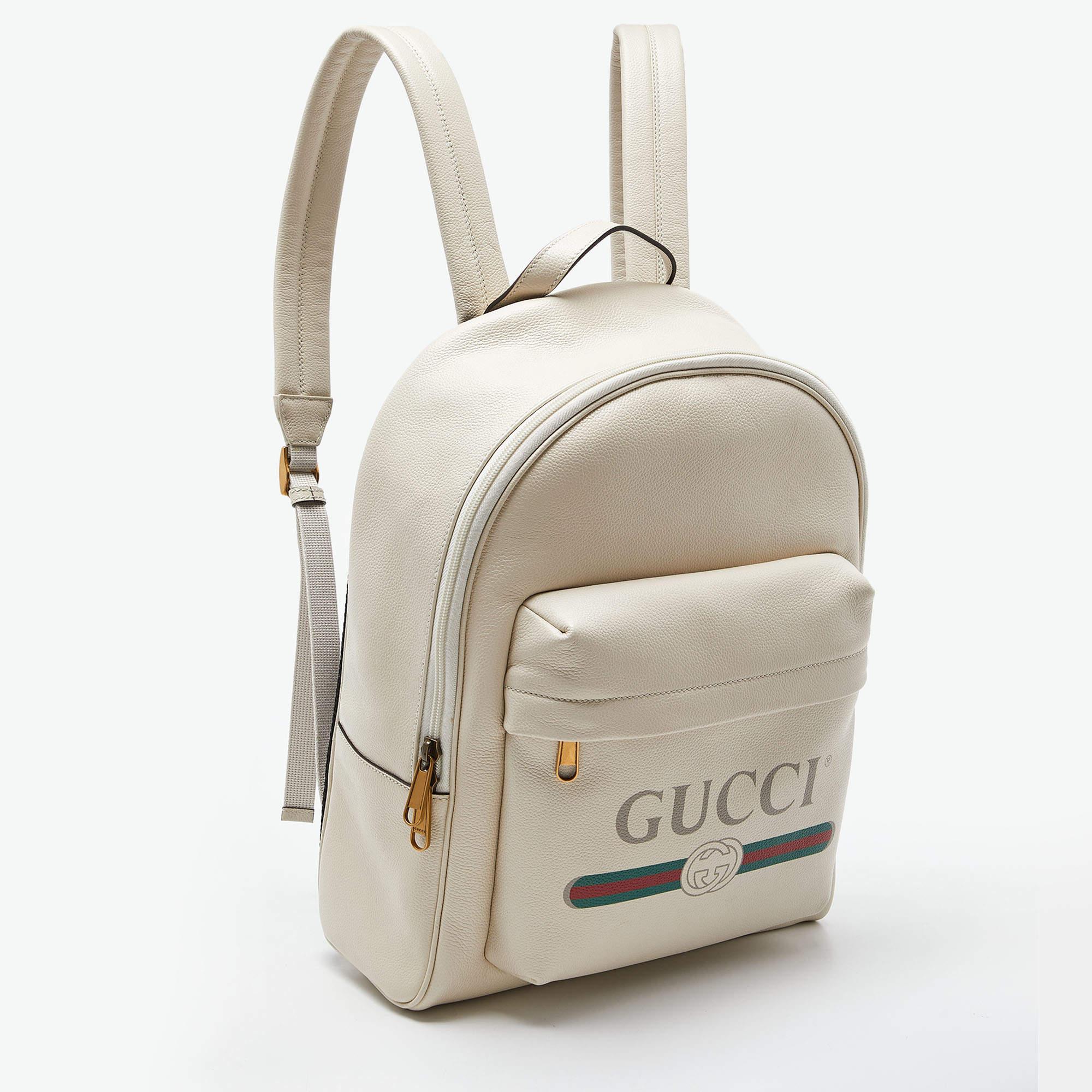 High functional and stylish, add a touch of luxury with this Gucci backpack. Crafted from leather in an cream hue, it features a front pocket accented with a vintage Gucci logo. The zipper closure opens to a spacious interior that makes it ideal for