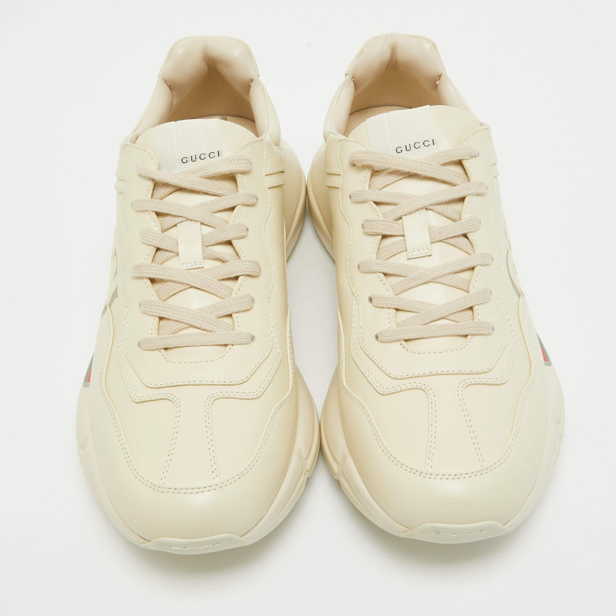 Designed into a chunky size, these Rhyton Gucci sneakers are not just stylish in appeal but also comfortable to wear. Crafted from leather, they are designed with logo prints atop a cream background on the sides. Finished off with laces on the