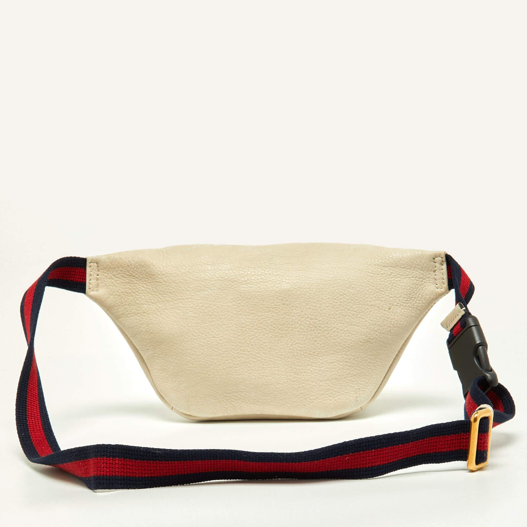 This uber-stylish Gucci waist belt bag aims to be an elevating piece. It is carefully created using cream leather and has the logo on the front. See how it transforms a T-shirt dress or a solid jumpsuit!

Includes: Info Booklet