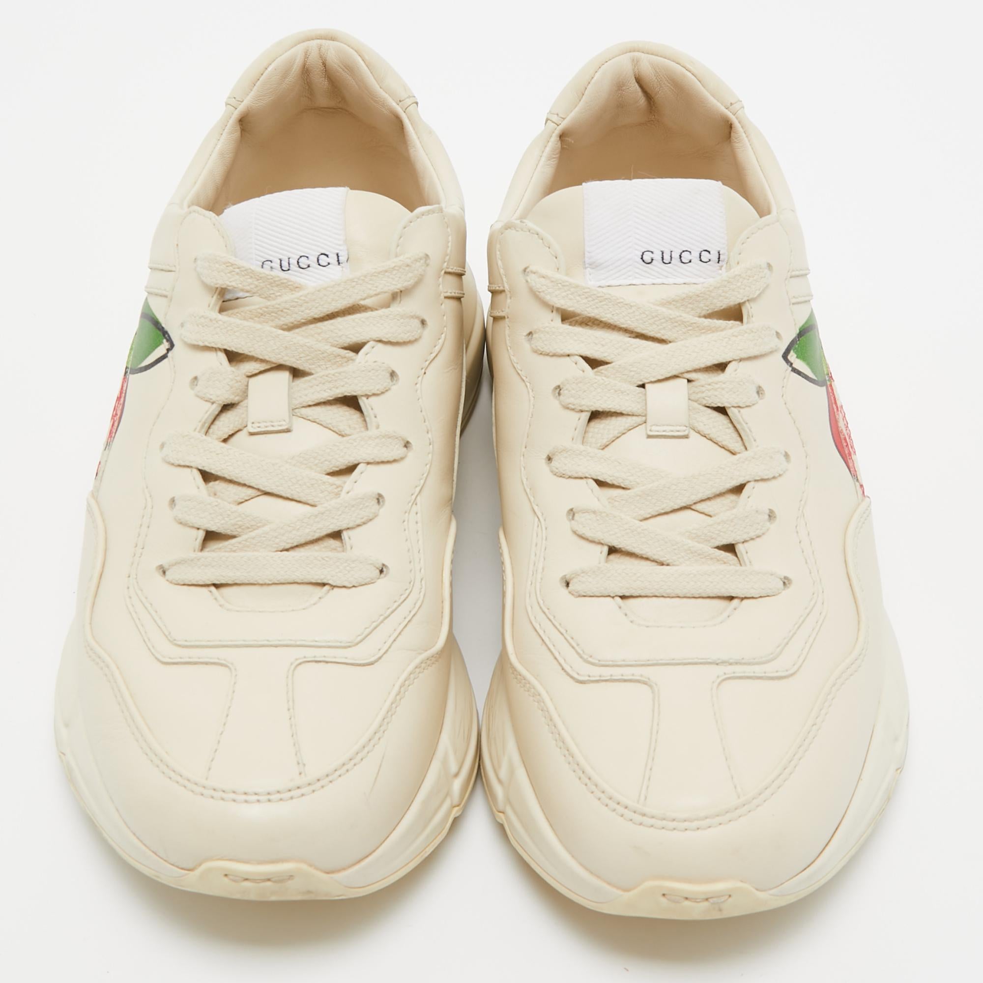 The time to feel trendy is now as Gucci brings you these superhit sneakers in a cream shade. They are crafted from leather, detailed with lace-ups, signature elements, and are set on highly comfortable soles. You are sure to receive nods of approval