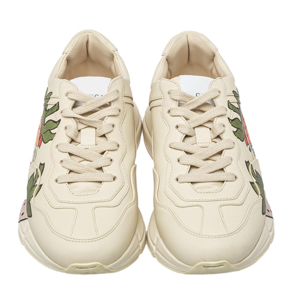 Gucci's popular Rhyton sneakers are elevated with sweet prints of strawberries thus presenting a fine balance of the sporty with the right element of fun. The sneakers are in leather, secured with lace-ups, and finished with flexible