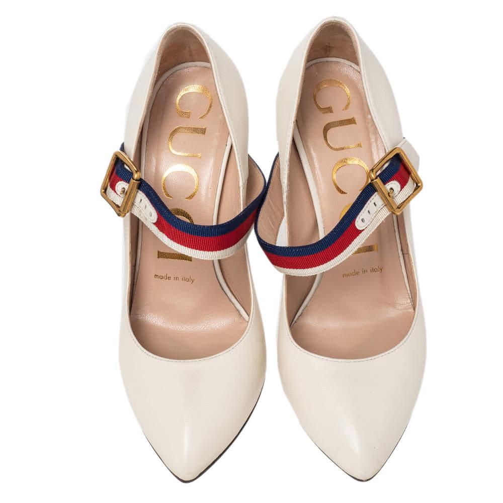 These Gucci Mary Jane Sylvie pumps exude a timeless appeal. Crafted from leather in Italy, they feature a signature strap with buckle fastening, pointed toes, and 10 cm stiletto heels. The white color adds to the appeal of the fashionable pair!

