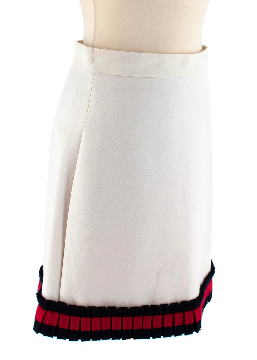 Gucci Cream Mini Skirt

- Silk blend skirt in cream
- Gucci red & blue stripe frill design on the edge
- Above the knee length
- Pink lining
- Zip fastening on the side
- Light weight material

Fabric Composition:
53% Silk
47% Cotton

Made in