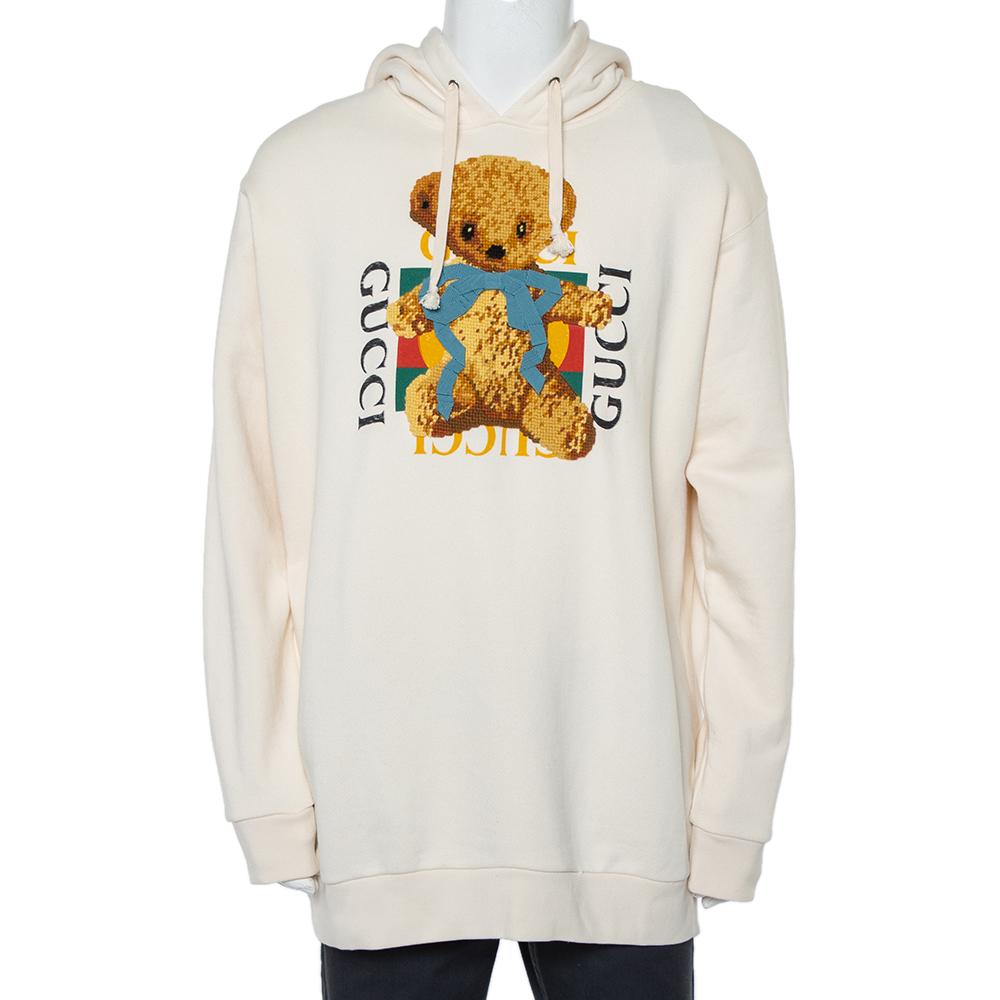 Get Gucci's signature comfort and style with this oversized hoodie. Made using cotton, the cream hoodie features appliqué detailing with brand logo on the front, a drawstring hood, and long sleeves.

Includes:  Brand Tag