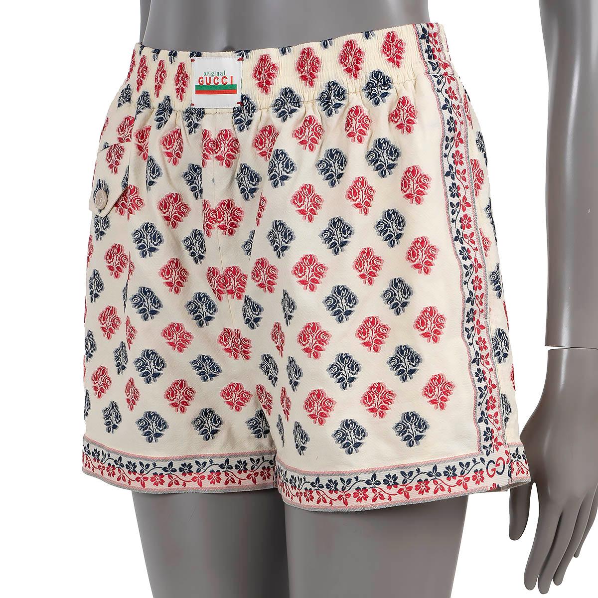 100% authentic Gucci floral jacquard shorts in ivory, pink and navy blue cotton (67%) and polyester (33%).  Features buttons flap pocket on the front and to slit pockets at the hips. Elastic waist ban with logo patch. Unlined. Have been worn and are