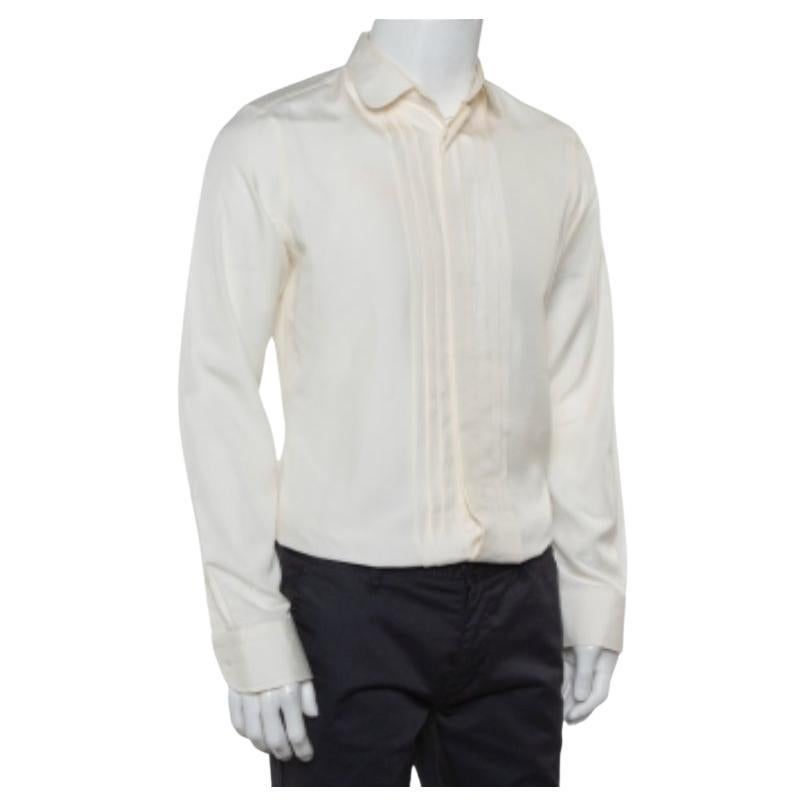 You cannot go wrong with an impressive shirt like this one from Gucci! Step out in confidence when you wear this cream skinny shirt. This 100% silk creation features a classic design with pintuck details, a collared neckline, and long sleeves. It