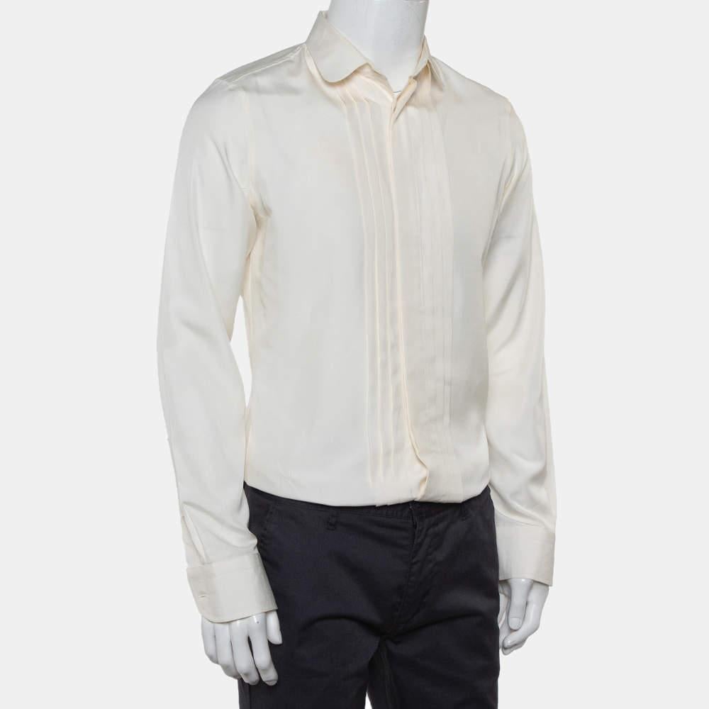 You cannot go wrong with an impressive shirt like this one from Gucci! Step out in confidence when you wear this cream skinny shirt. This 100% silk creation features a classic design with pintuck details, a collared neckline, and long sleeves. It