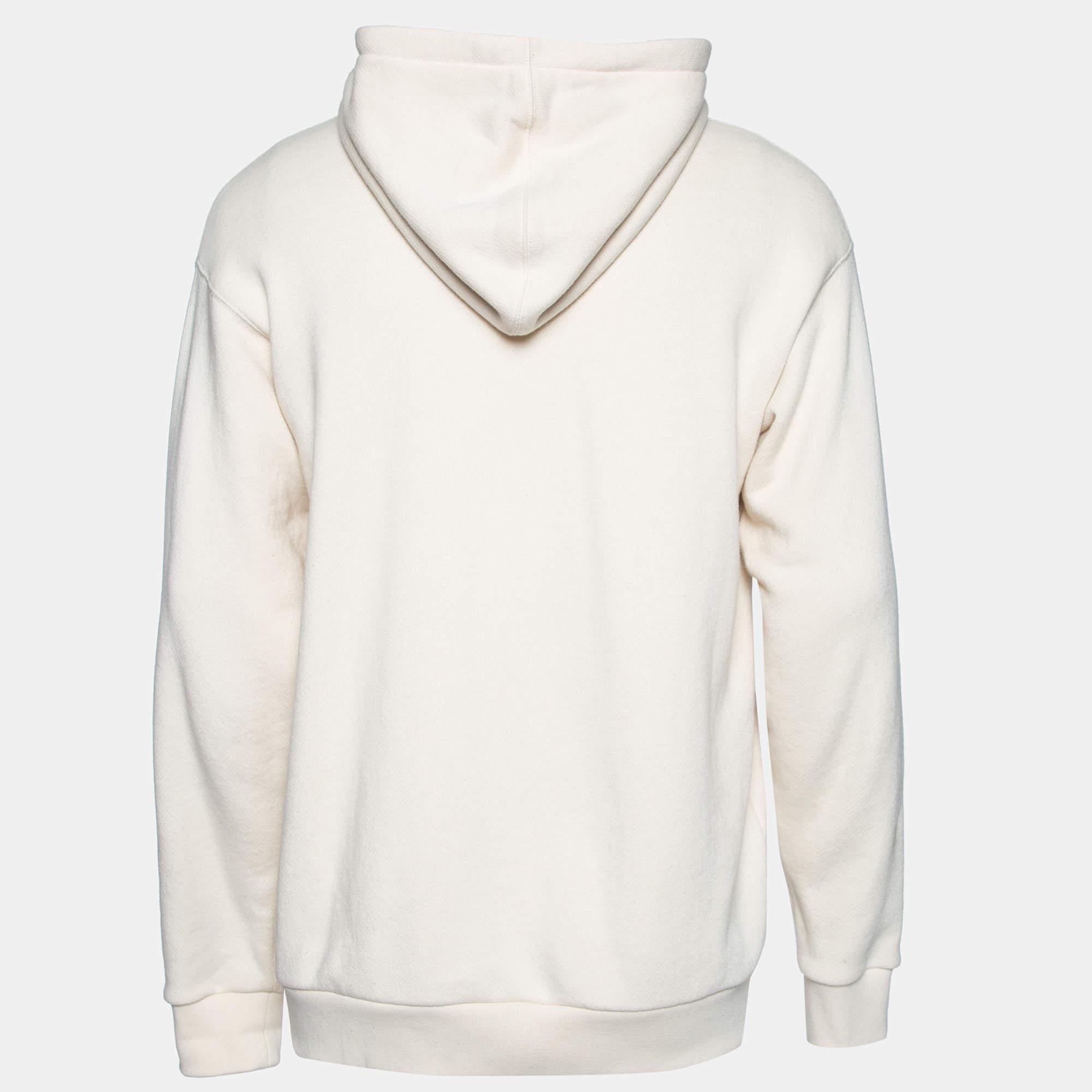 This hoodie from the House of Gucci will keep your style trendy and classy! It is made from cream terry knit fabric, which shows a multicolored print and a pearl-embellished logo on the front. It has long sleeves. This stunning Gucci hoodie will