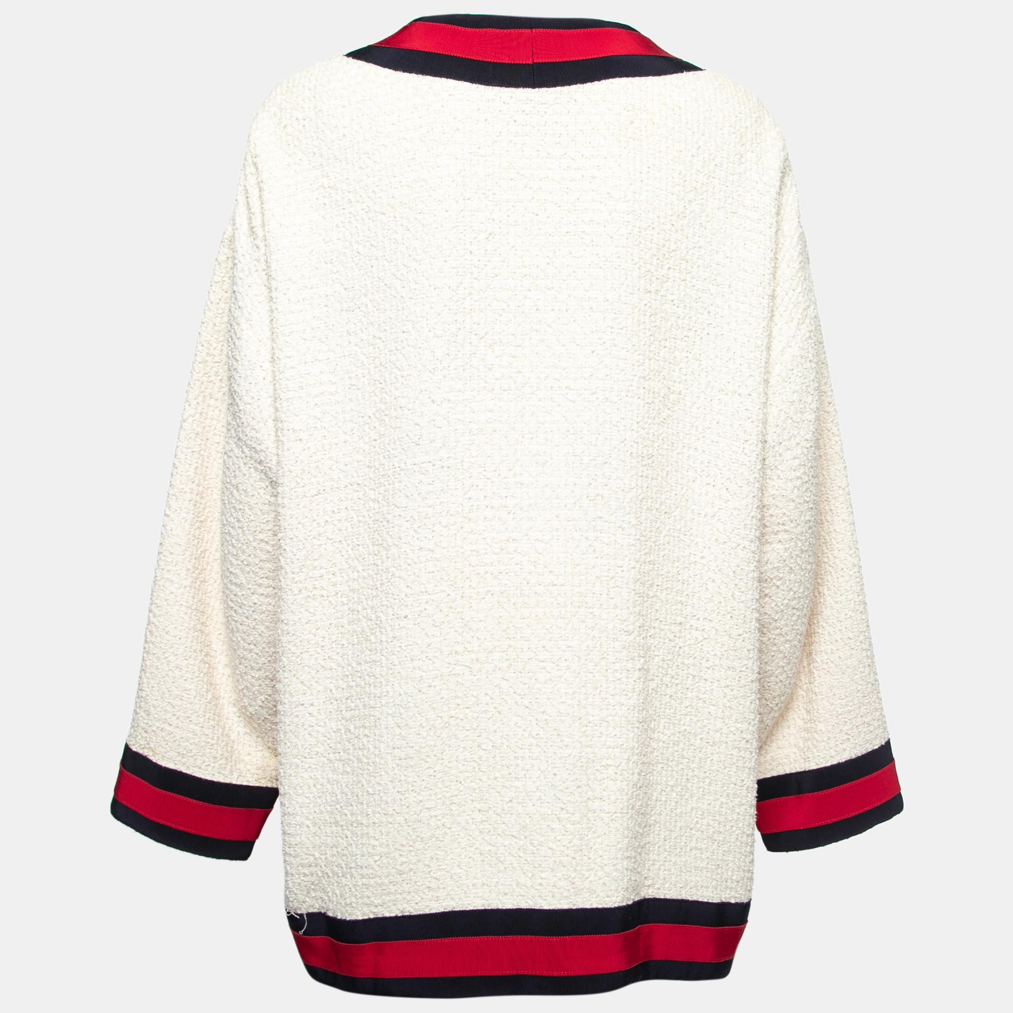 Gucci takes its archival Web and brilliantly fits into the current trend of clothing. Made from tweed fabric, the cardigan comes with a front button closure, an oversized fit, and long sleeves.

