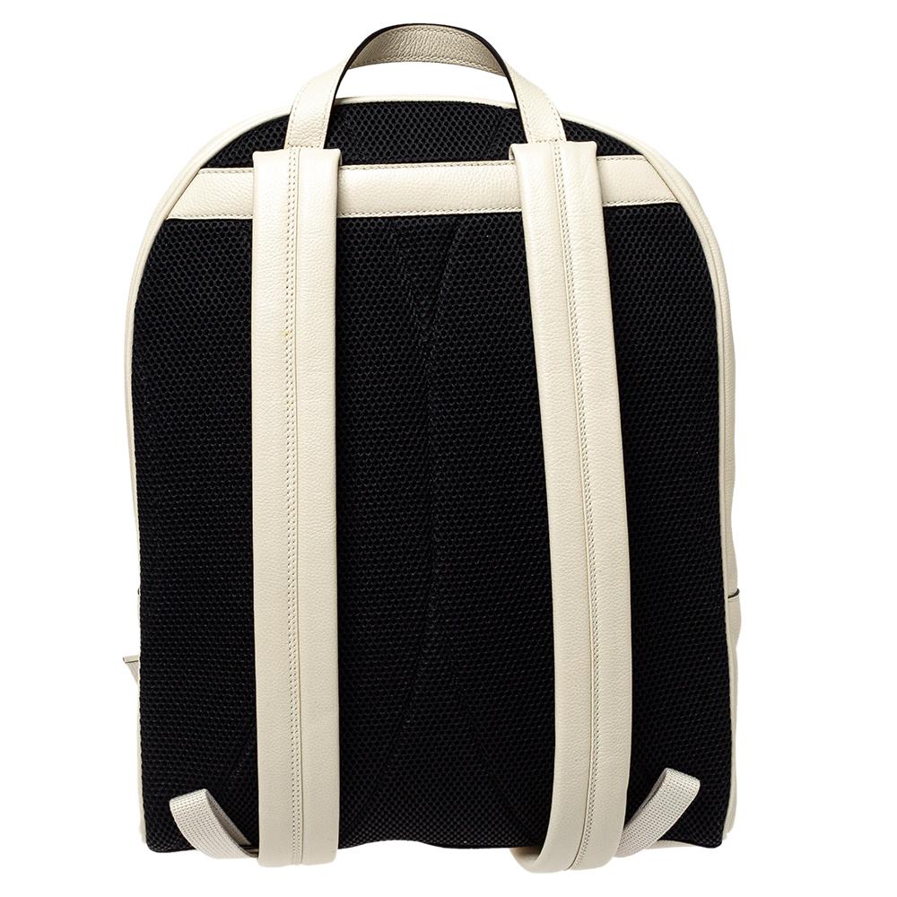 The backpack continues to be an coveted silhouette in the world of Gucci, offered in a variety of sizes and interpretations. Here, this creamish-white leather is juxtaposed with a black back, the Gucci logo on the front pocket is inspired by vintage
