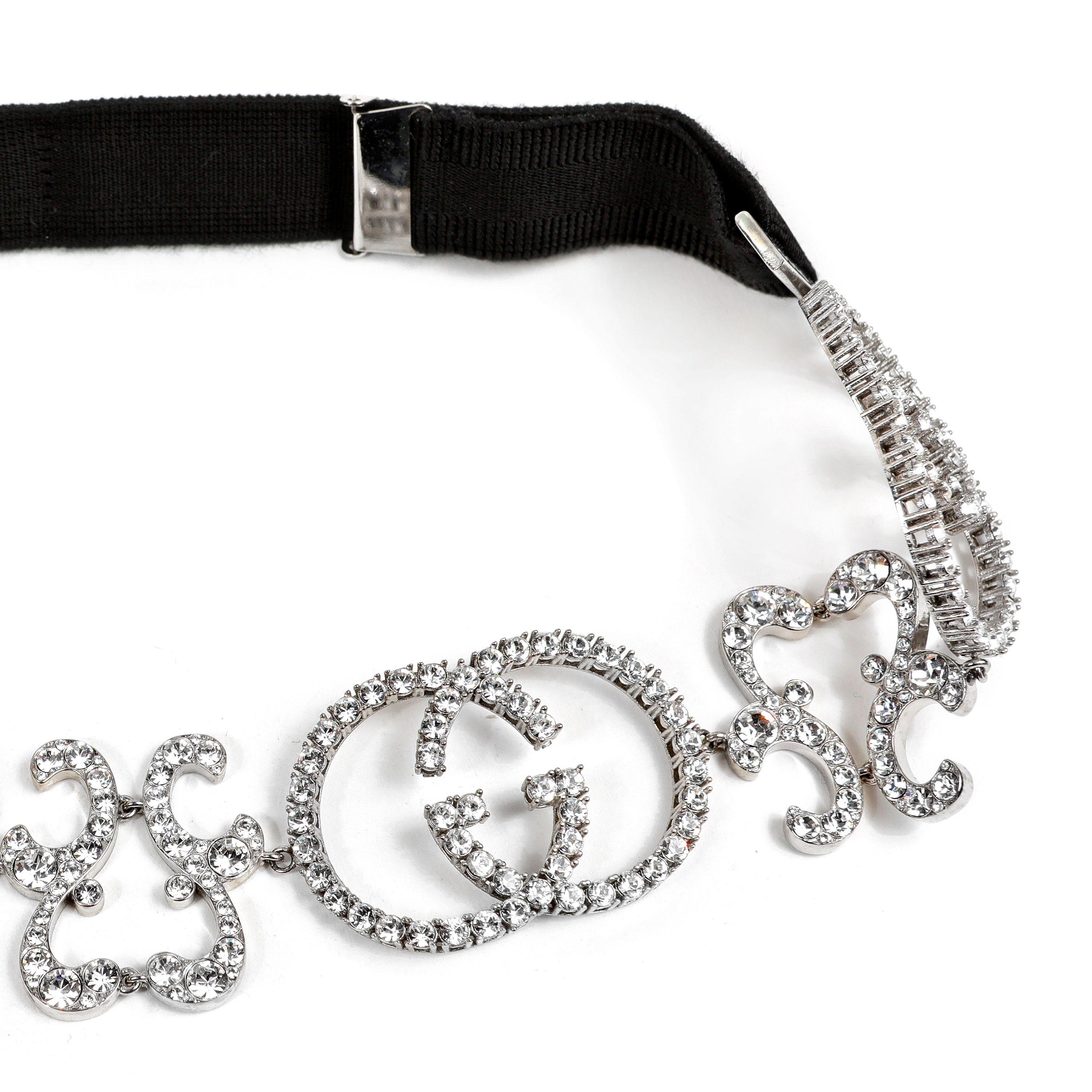 This authentic Gucci Crystal GG Headband is in pristine condition.  Black adjustable length band with intricate GG crystal design attachment.  
PBF 13805
