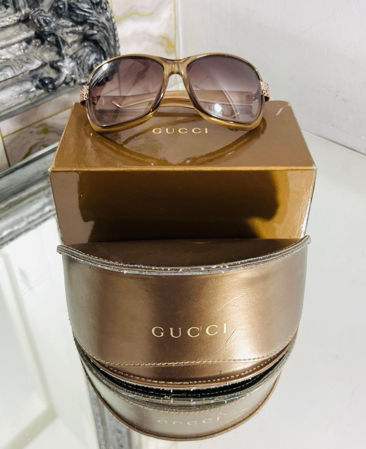 Gucci Crystal GG Sunglasses

Havana, dark beige/gold sunglasses designed with oversized rounded rims and gradient purple lenses.

Detailed with 'GG' logo and crystal embellishment to the hinges.

Size – One Size

Condition – Very Good

Composition –